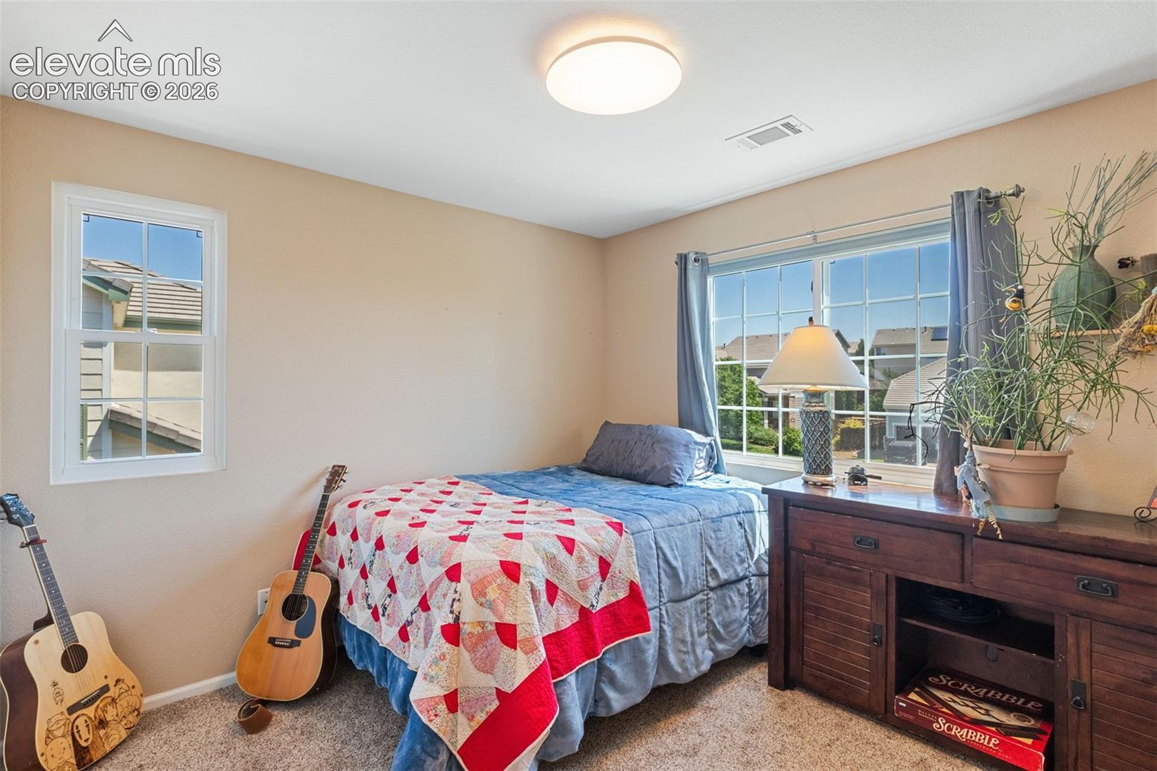 Bedroom 2. More large windows providing lots of light.
