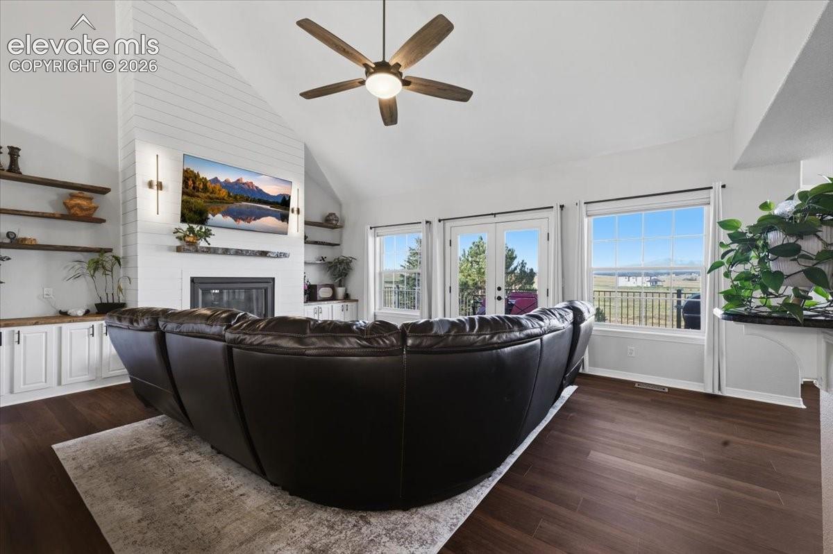 living room with gas fireplace, built ins and walkout to deck