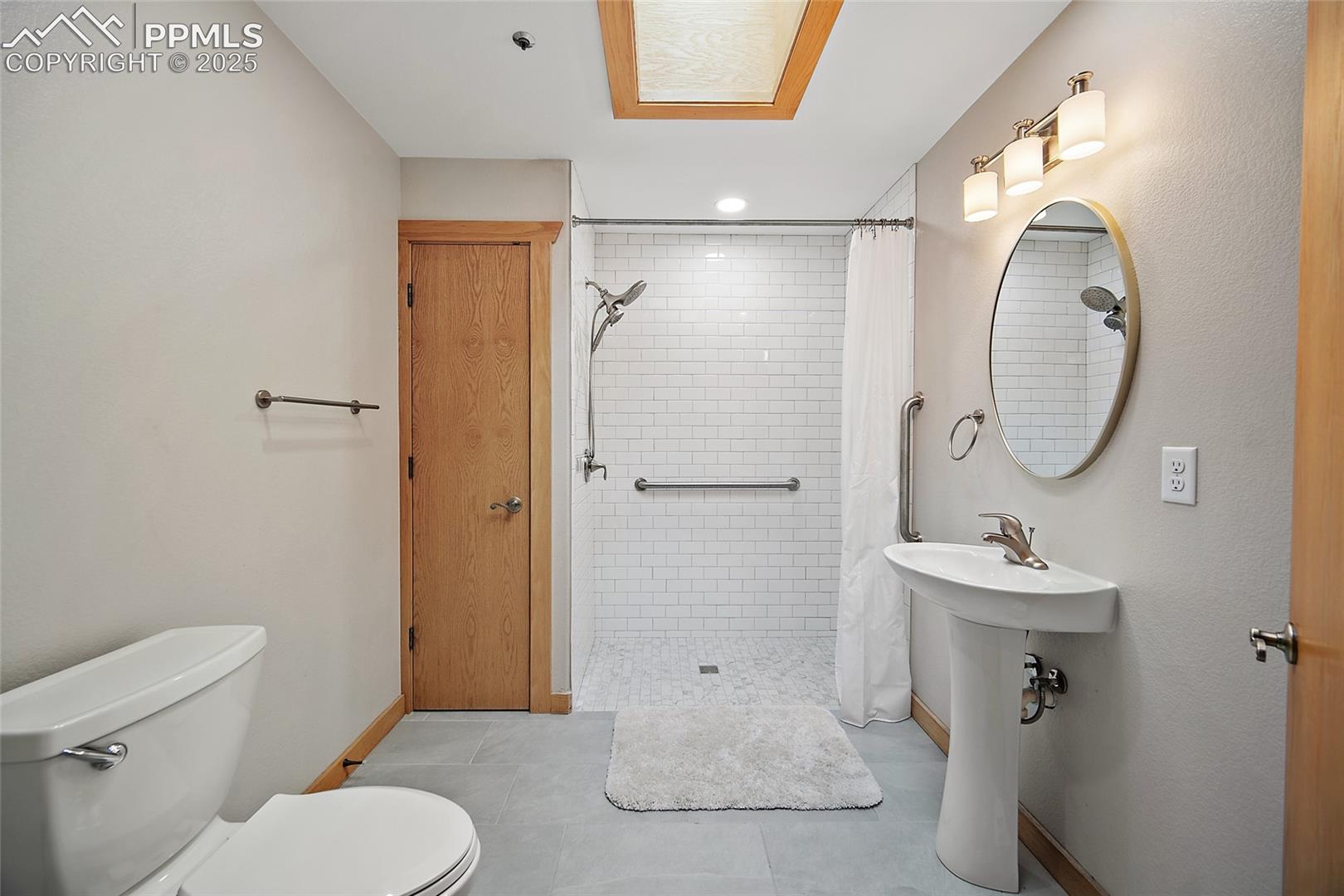 Full bathroom featuring a shower stall, tile patterned floors, and recessed lighting