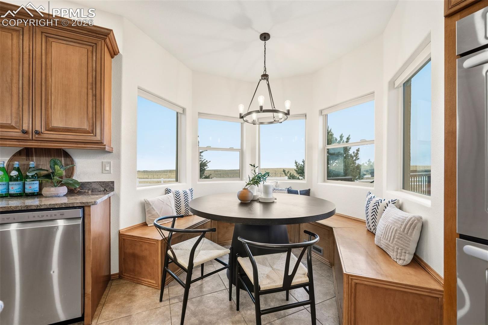 Custom built seating for the kitchen table takes advantage of the bay windows and view