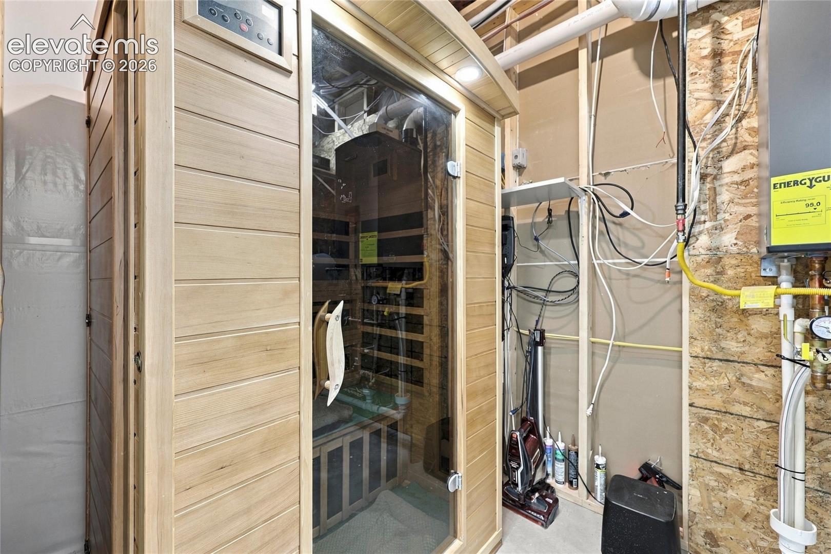Infrared sauna featuring natural wood-finish paneling, tempered glass door, and integrated digital controls