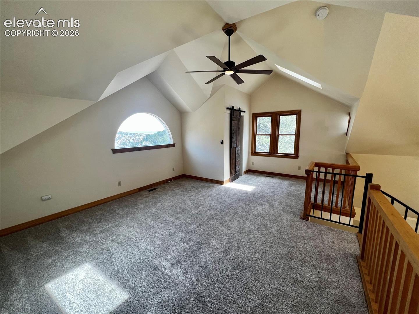 Custom Cottage: Loft bedroom with walk-in closet and spiral staircase