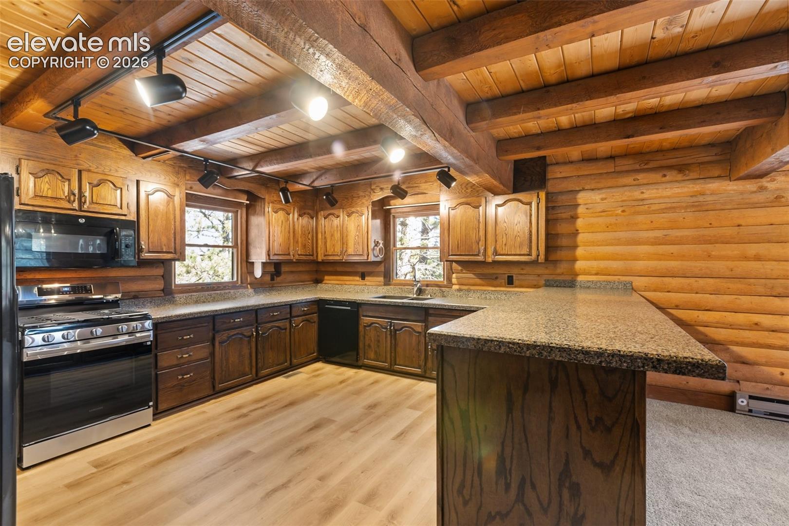 All cabinets refinished. Huge counter area. New range and microwave. Accommodates gas or electric range.