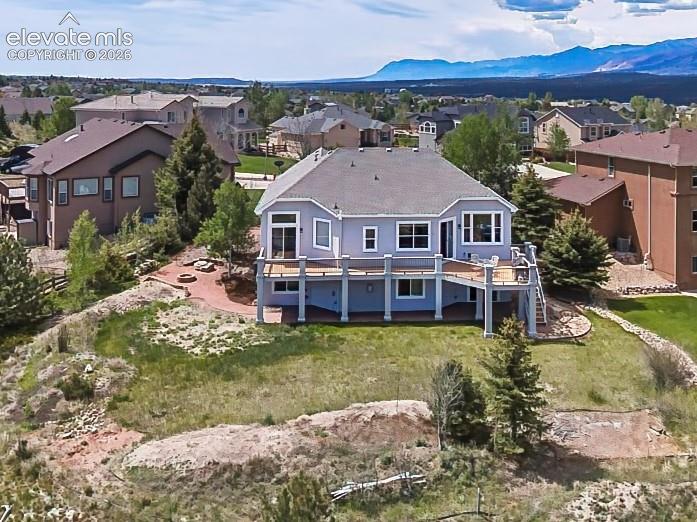 Expansive backyard with a large elevated deck and open green space, perfect for outdoor enjoyment and entertaining.