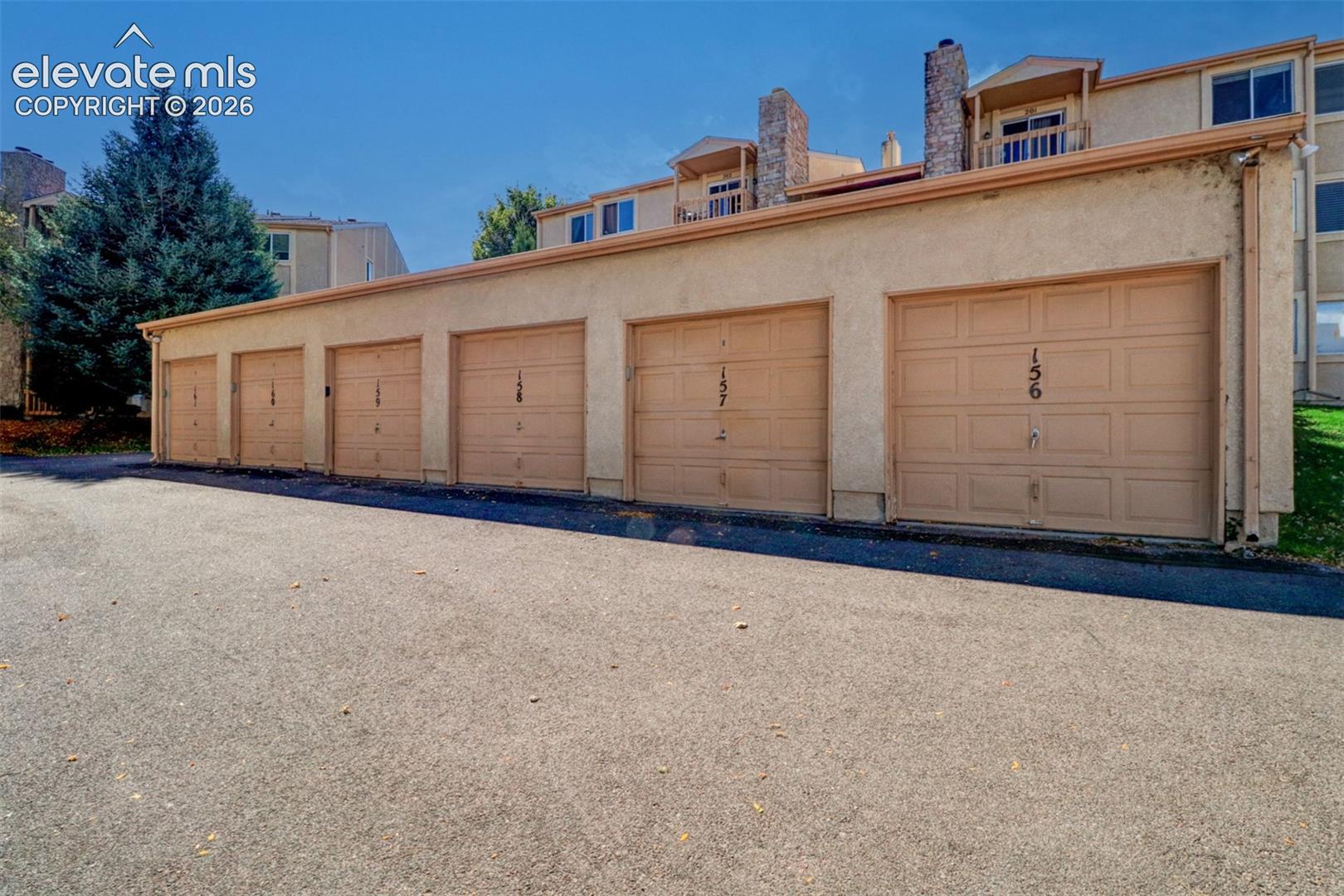 Exterior view of garage (#157) with stucco siding. 