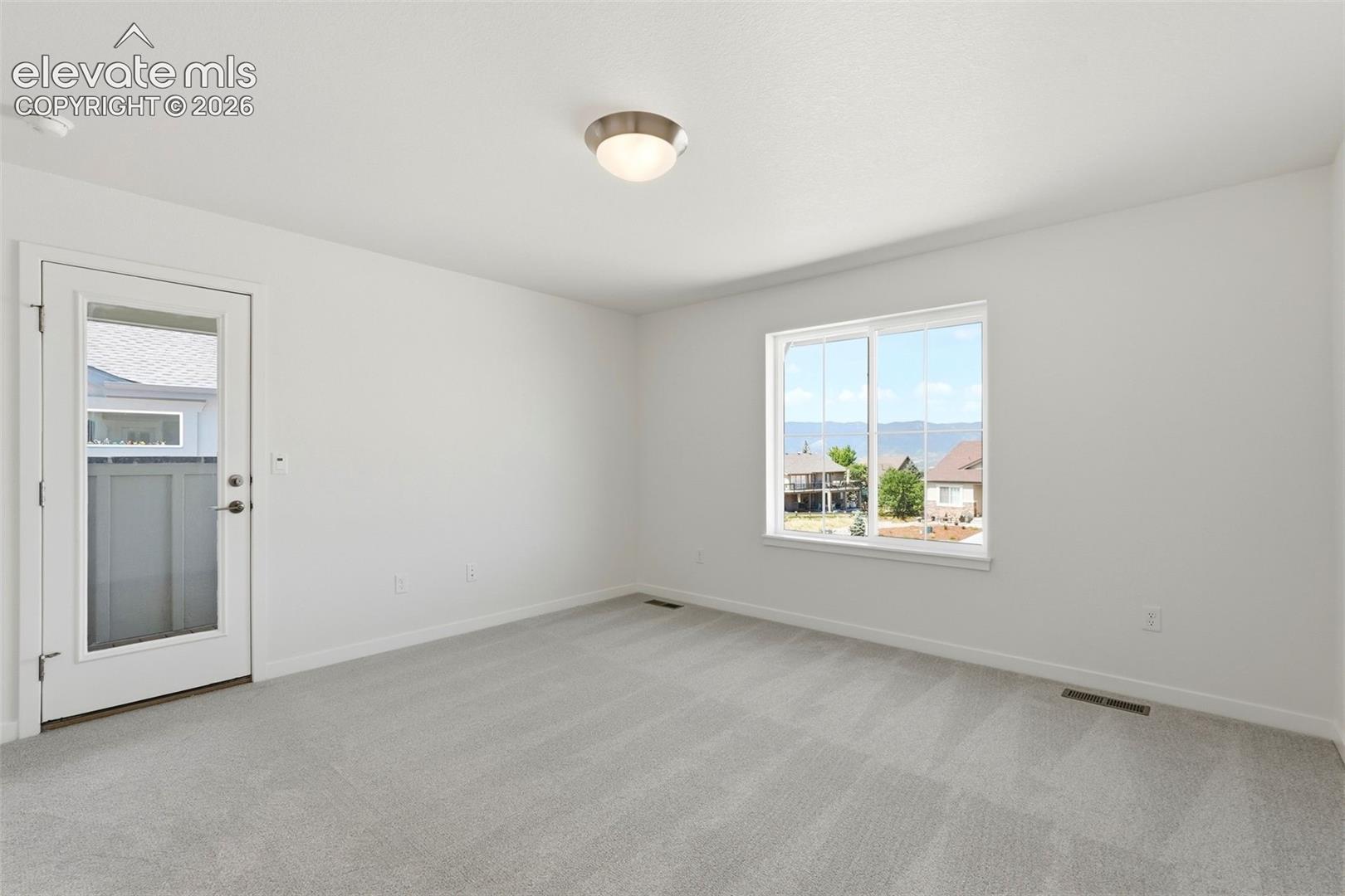 The Primary Bedroom walks out to the Covered Balcony