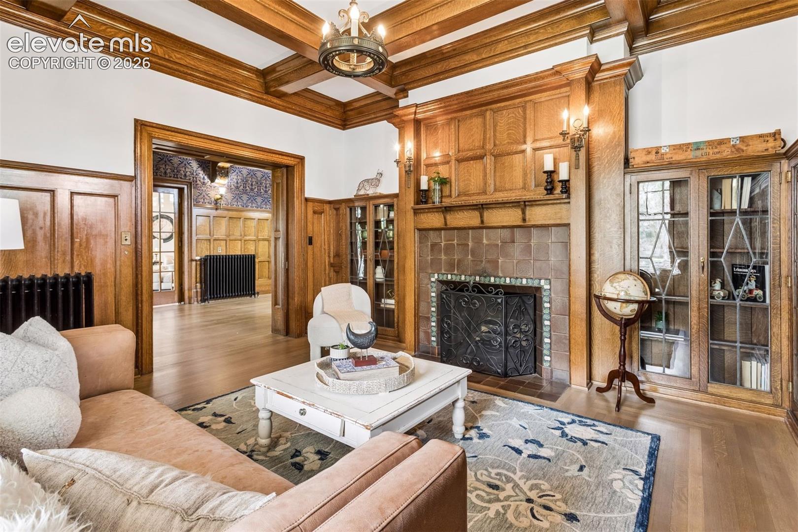 1 of seven Van Briggle fireplaces Glass-enclosed built-in bookshelves, brown/reddish Van Briggle tiles.

