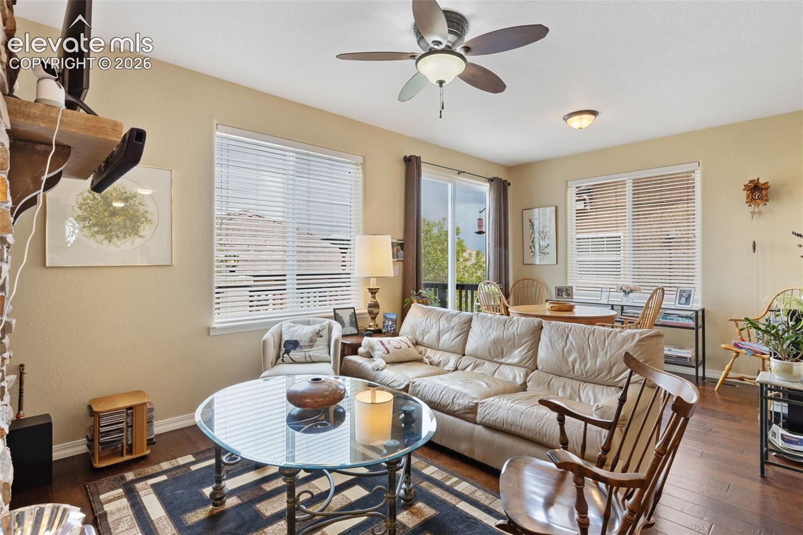 Living area featuring wood-finish flooring and multiple windows