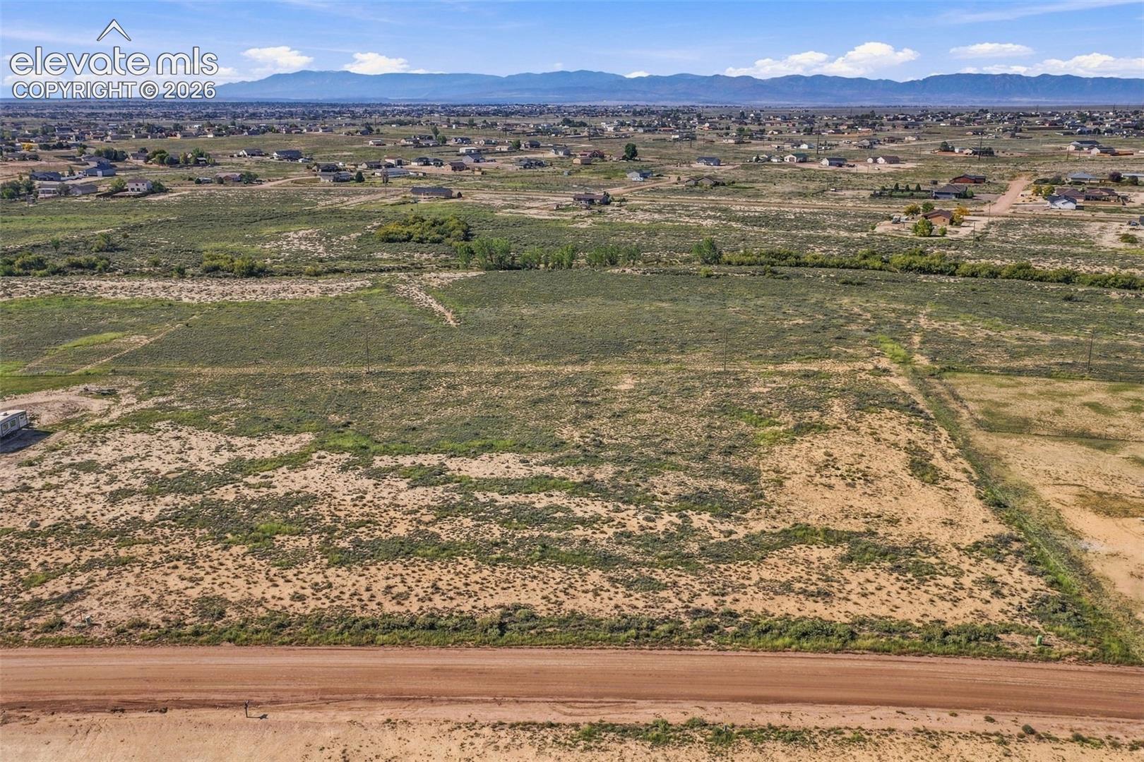 Expansive, undeveloped acreage featuring prominent mountain range horizons and unencumbered terrain