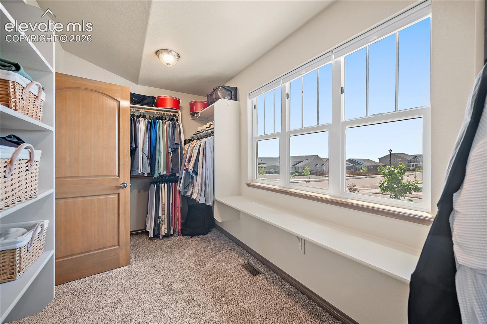 Walk in closet with a wall of windows for natural light. 