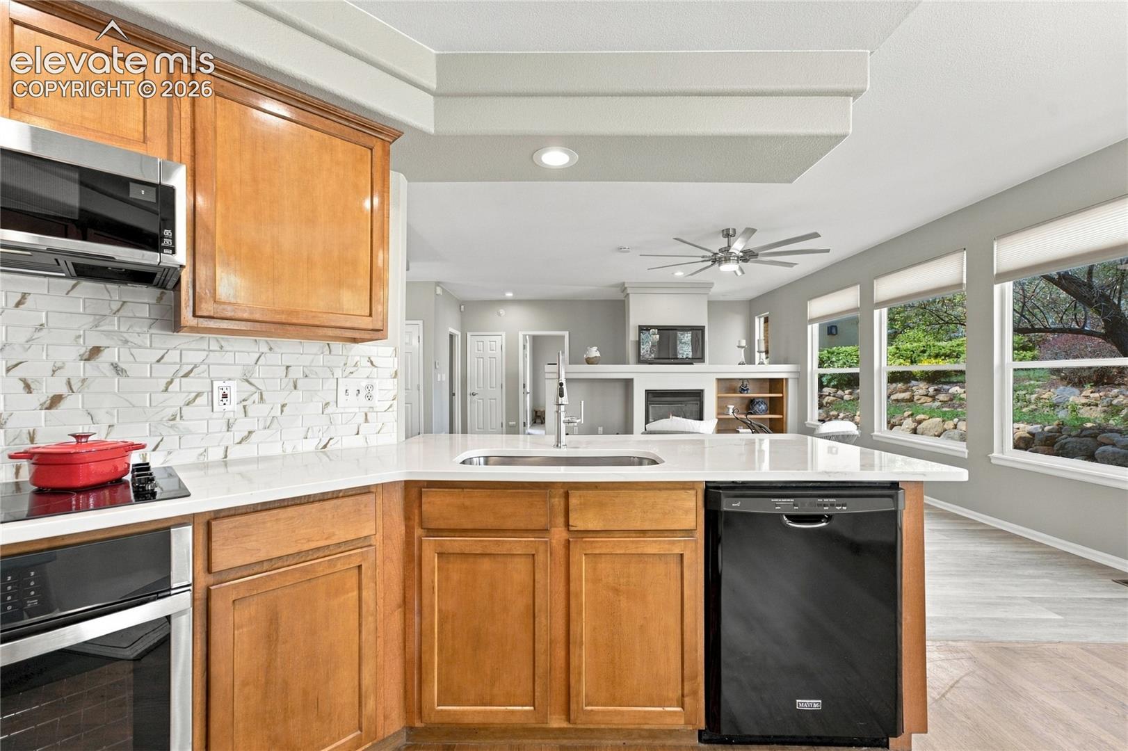 open concept kitchen adjoining kitchen nook and overlooking the living room