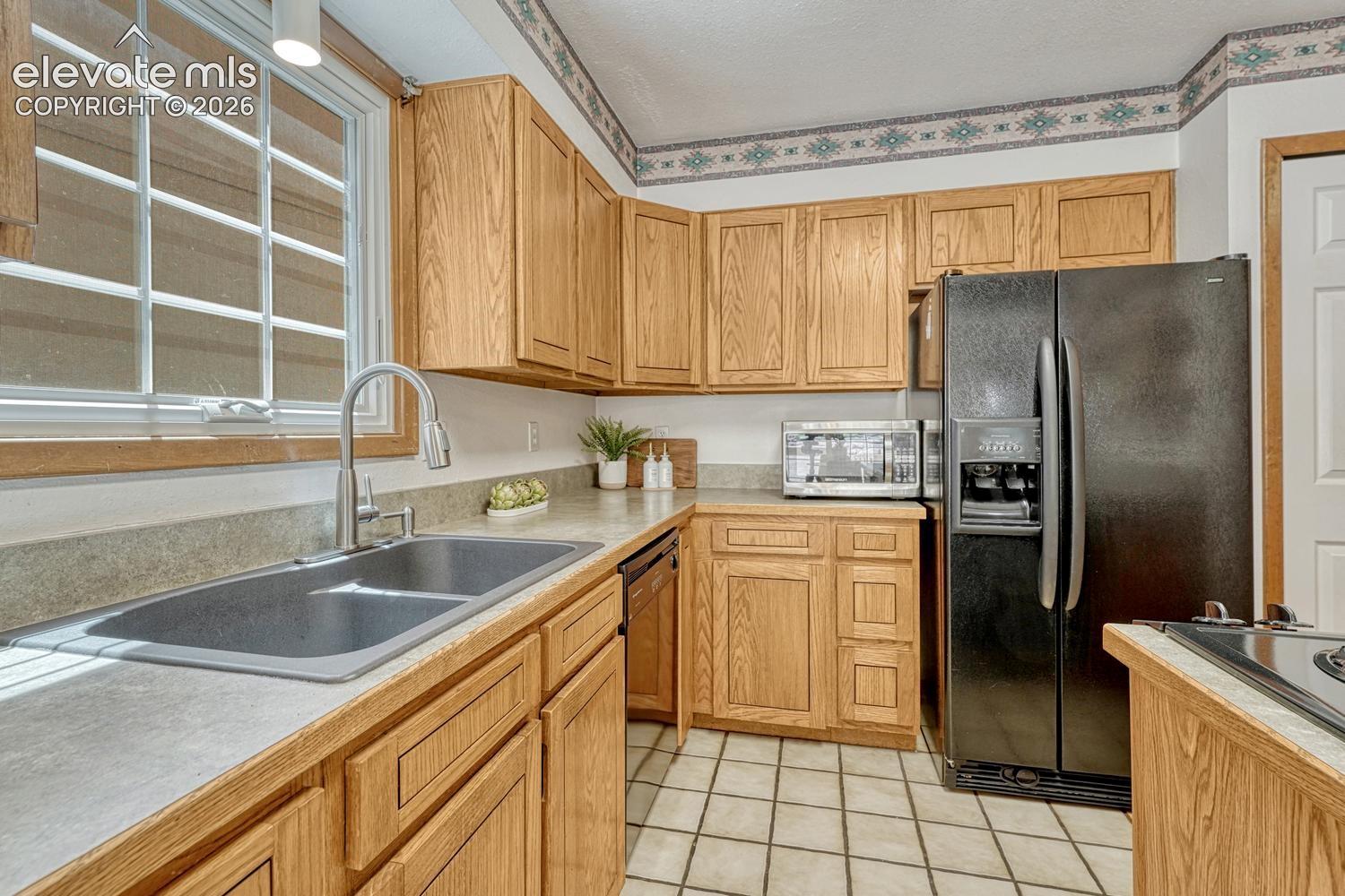 Inviting kitchen with two pantries, beautiful wood cabinetry and lots of counterspace for kitchen storage and easy food preparation.