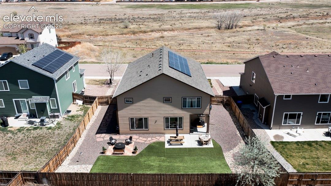 Backyard, astroturf, covered patio, firepit, flagstone walkway, storage shed, solar panels