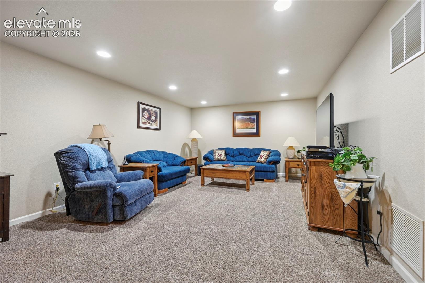 Spacious Family Room featuring neutral carpeting, light-toned wall paint, and recessed ceiling lighting