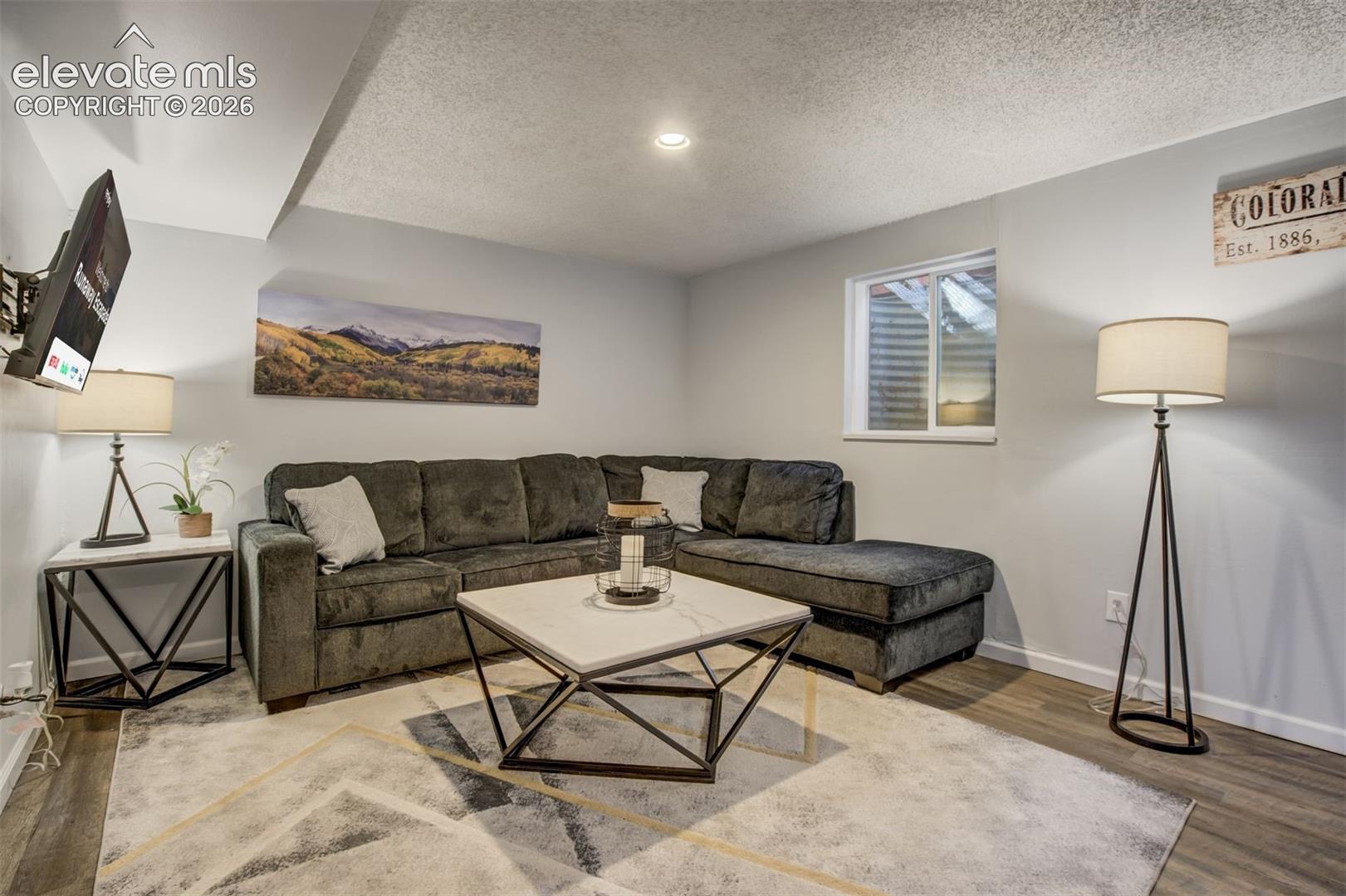 Recessed lighting, wood-finish flooring, and a low-profile window