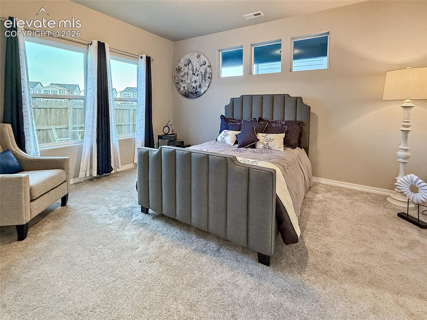 Neutral-toned walls complement the carpeted flooring