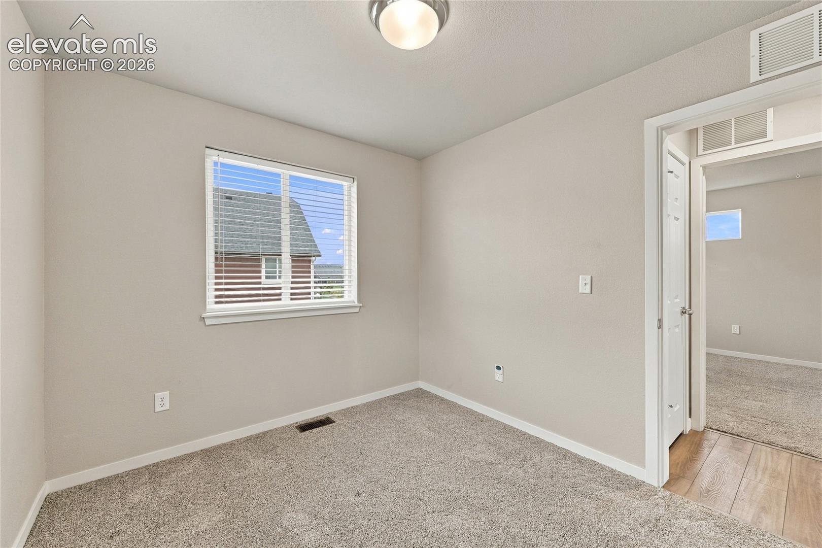 Neutral wall color with wall-to-wall carpeting