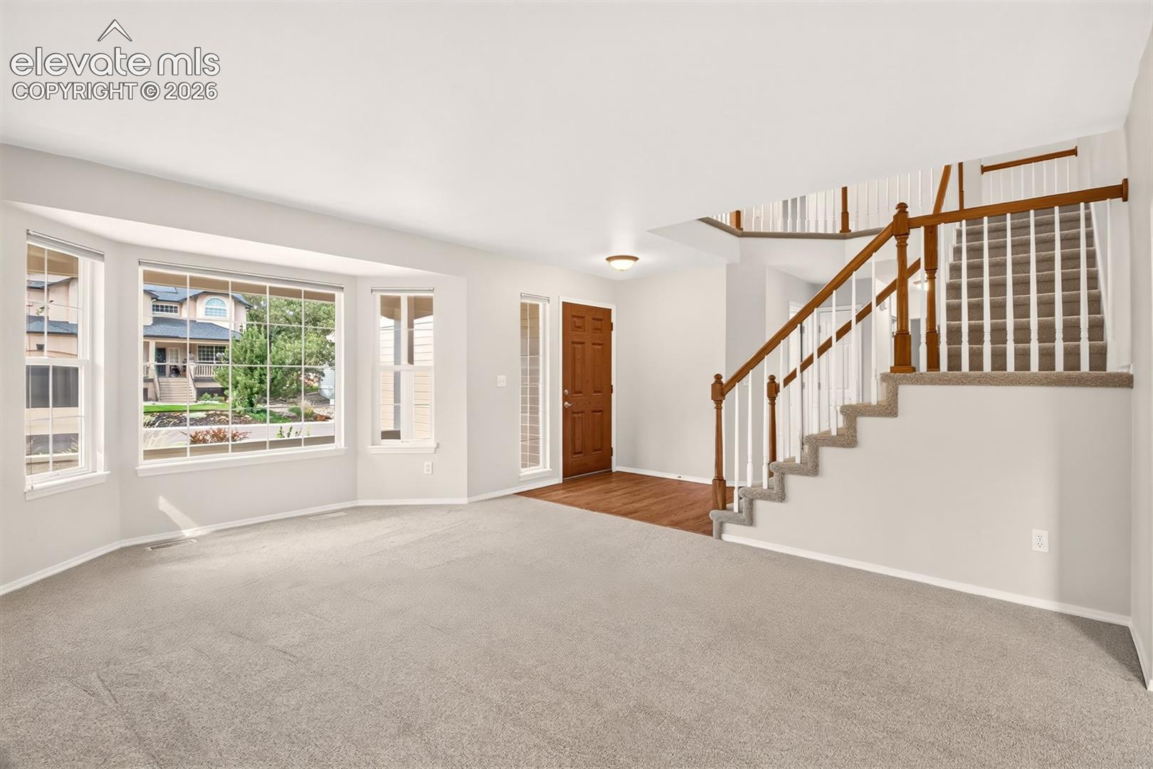 Heading Upstairs, Wood Floors Leading Into The Kitchen, Garage Entry, And Main Level Bath