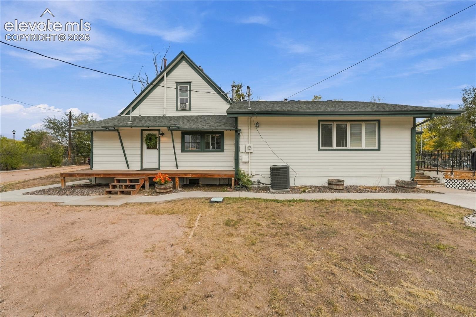 Rear view of home, back covered porch and private Primary deck