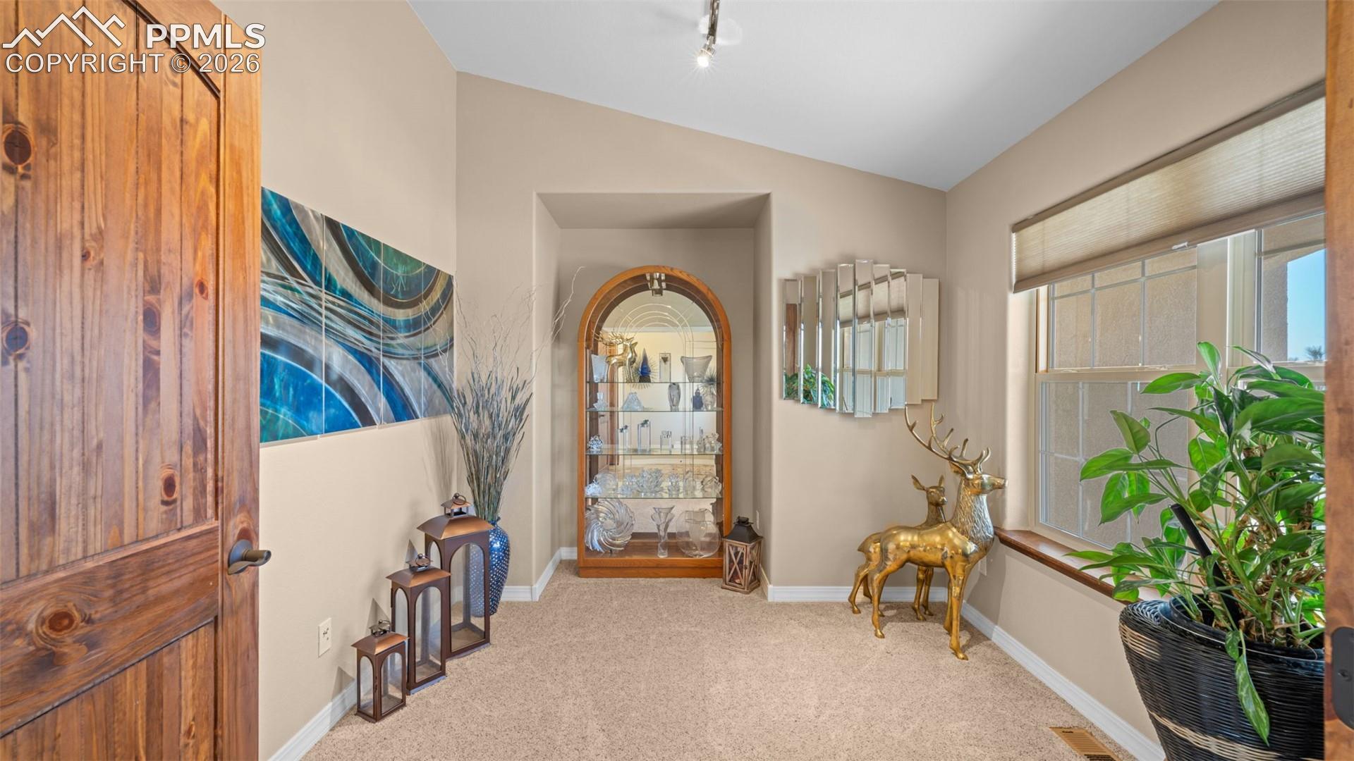 Double door entry flex room, potential office, formal dining or possible 5th bedroom, lofted ceiling, and rail lighting