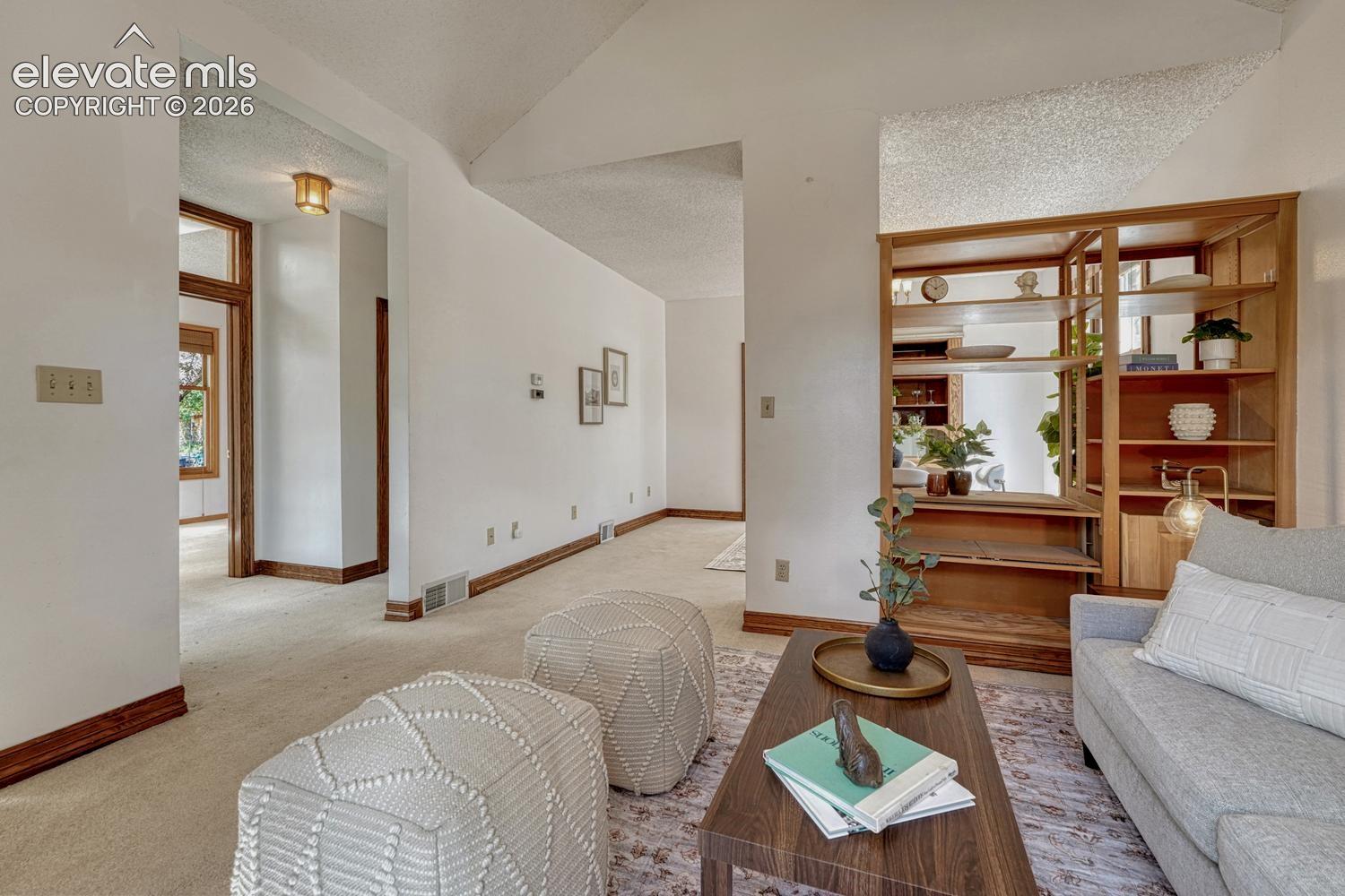 Built-in wood shelving, light-colored carpet flooring, and wood trim accents.