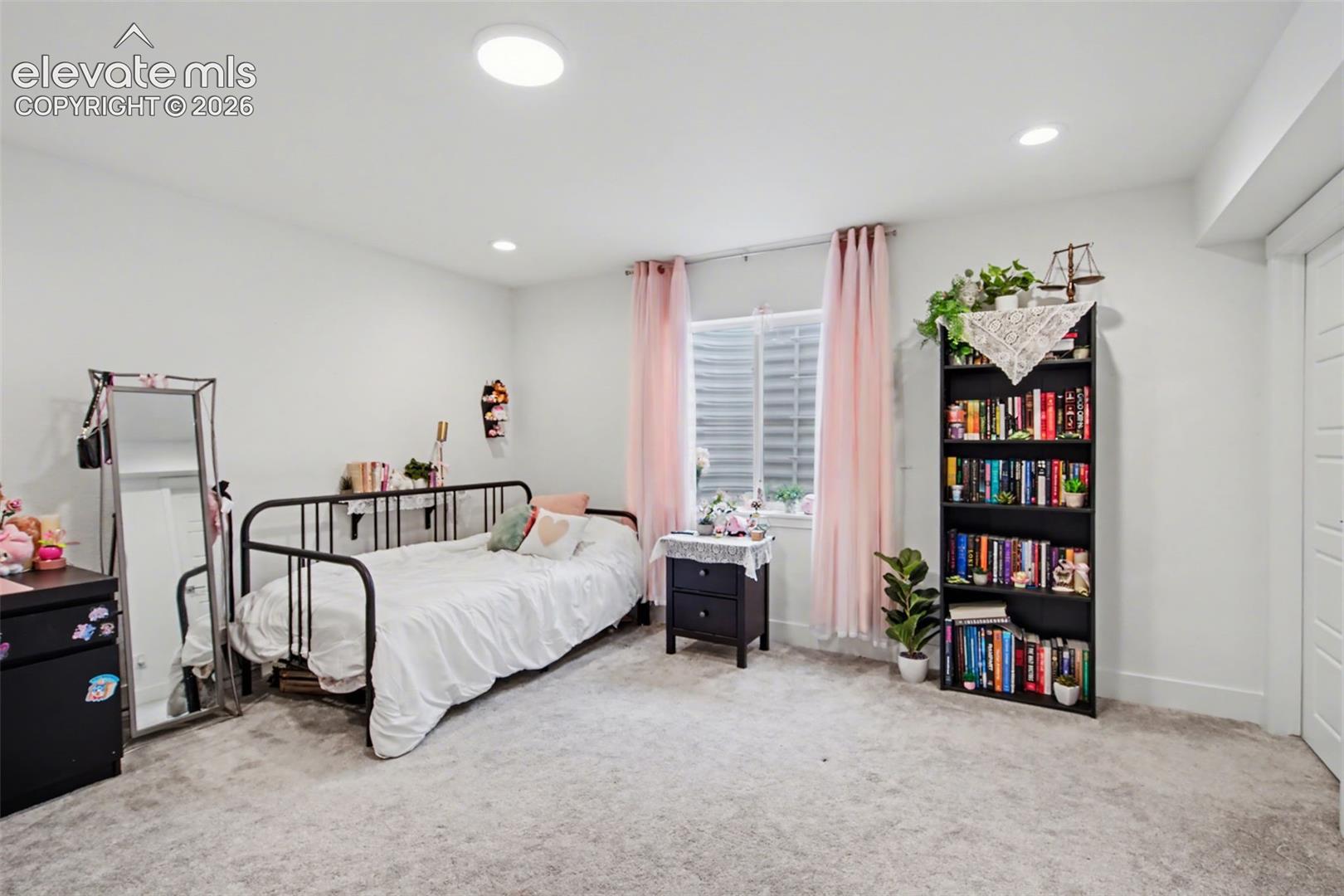 Carpeted bedroom with recessed lighting and baseboards