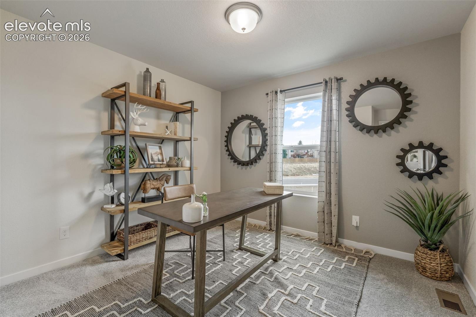 Recessed lighting, light-toned wall paint, a window with natural light, and carpeted flooring