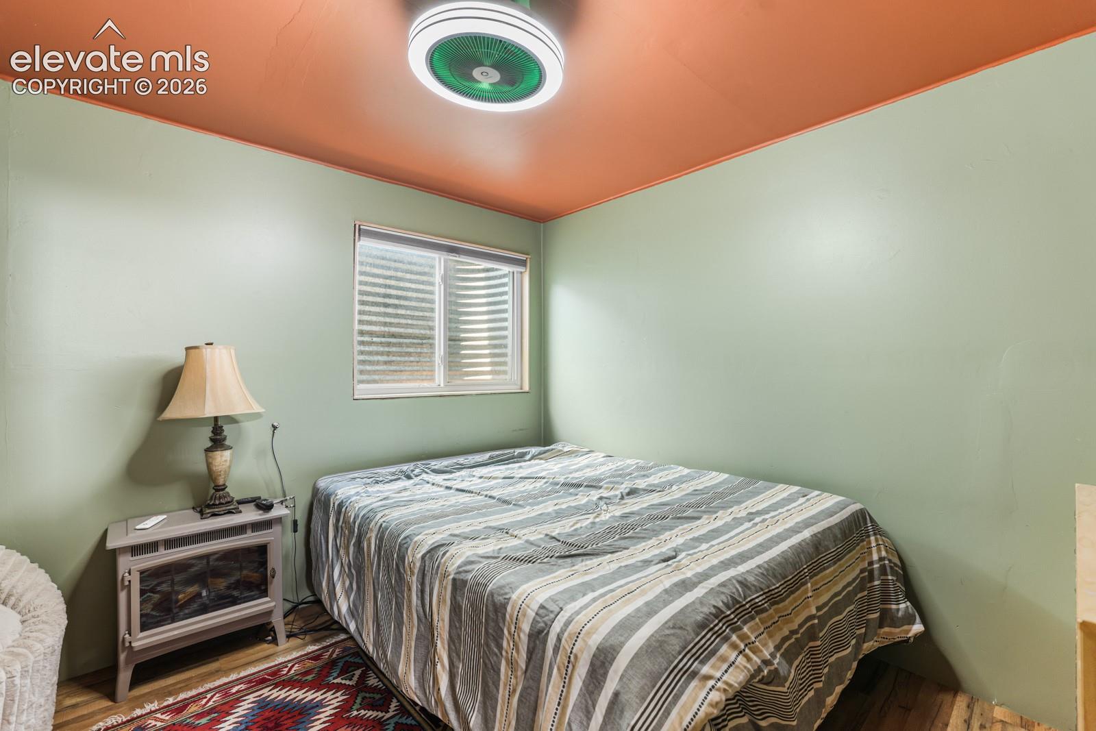 Interior room with wood-finish flooring and light green walls