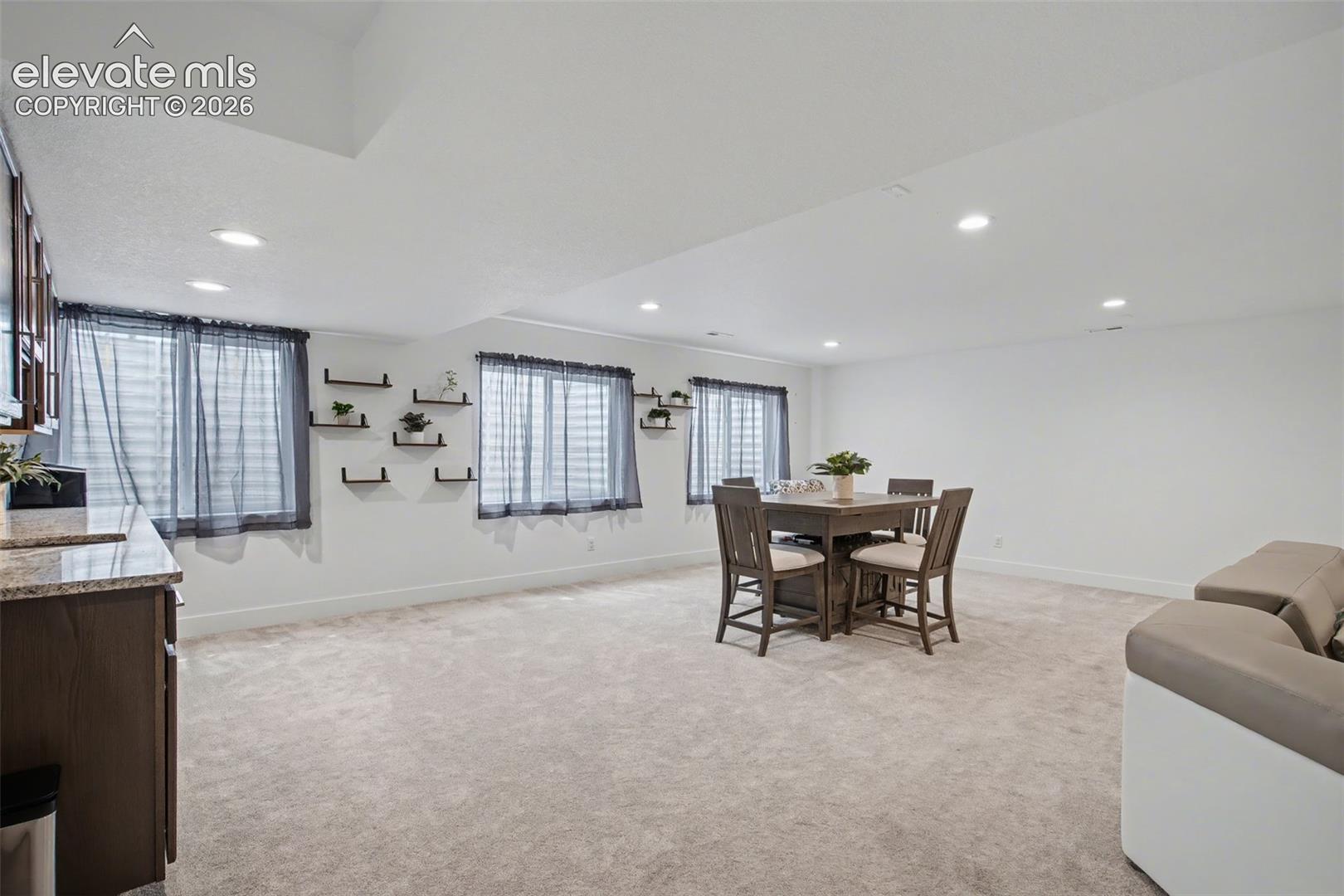 Dining room featuring light carpet and recessed lighting