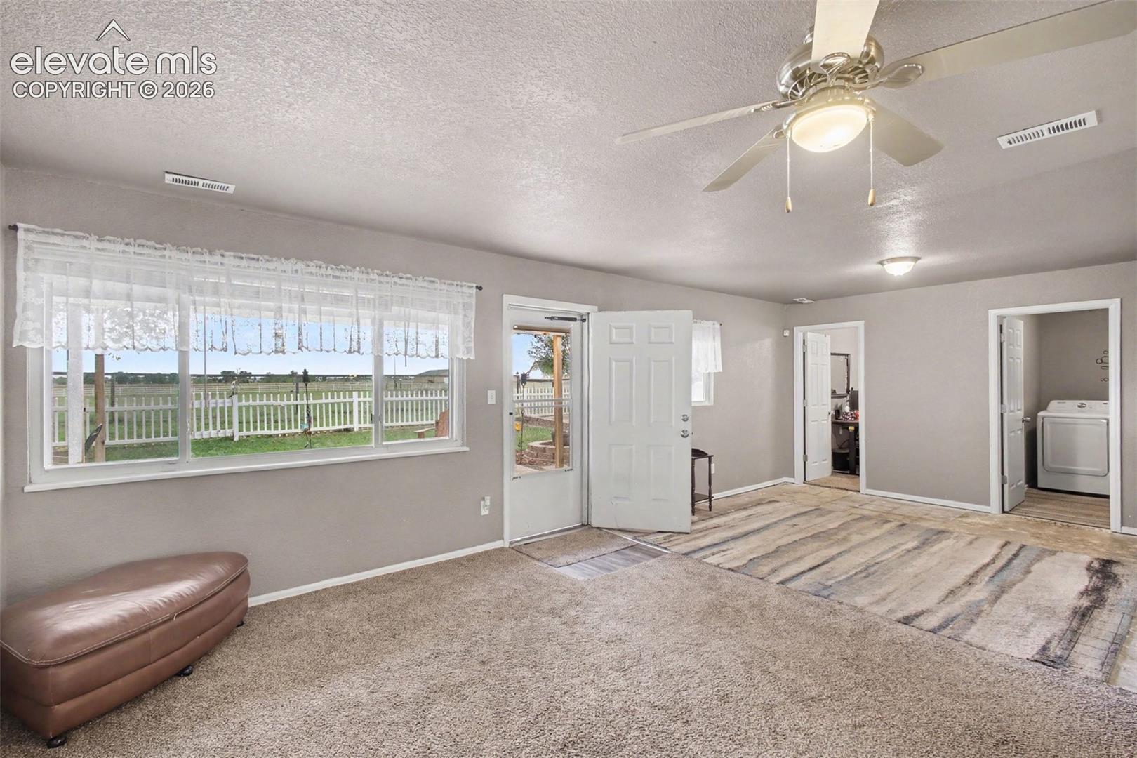Inviting 2nd living room featuring a walkout to the back patio, creating an easy connection to the exceptional outdoor living space and beautiful surrounding views.