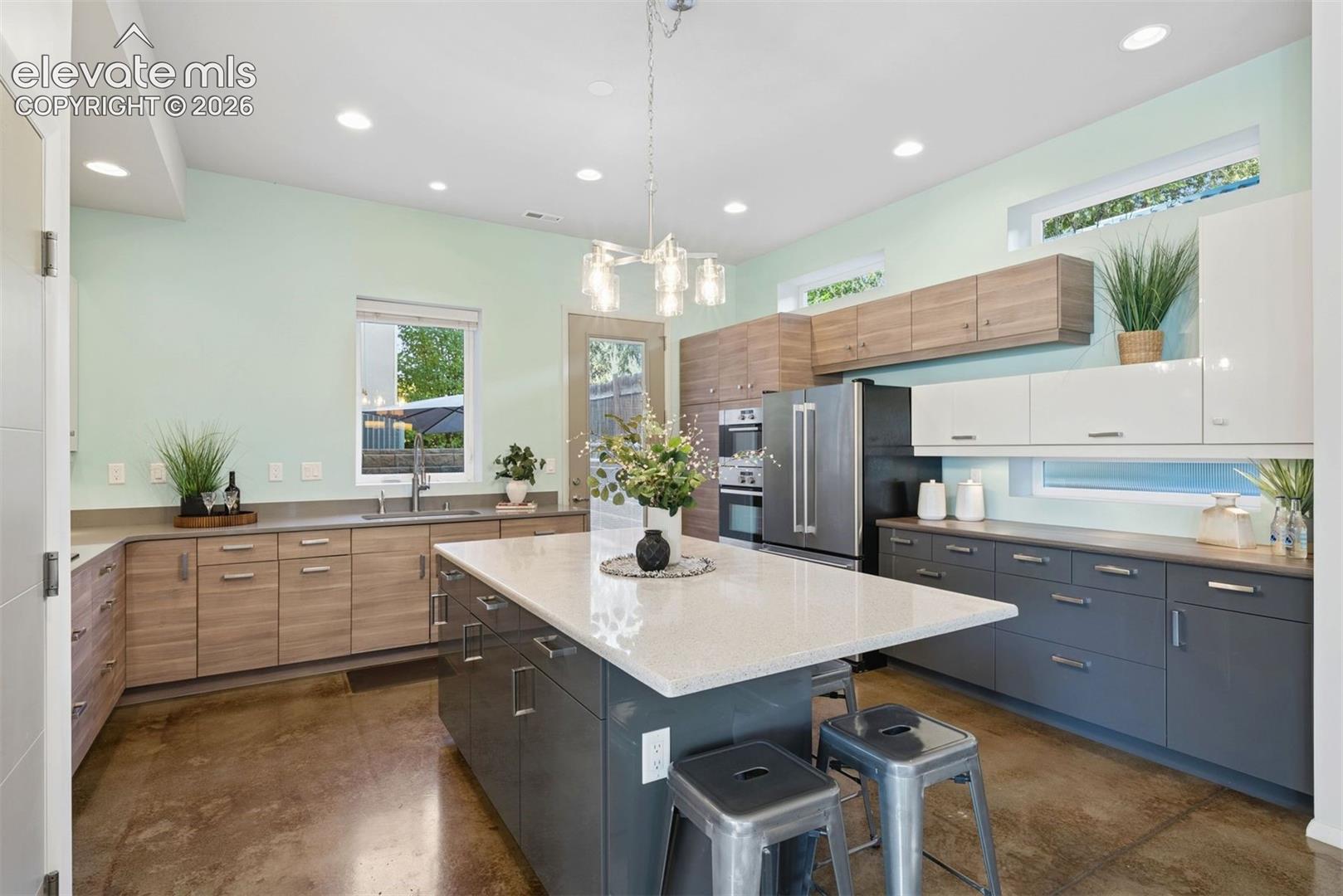 Three tone slab-faced cabinetry 