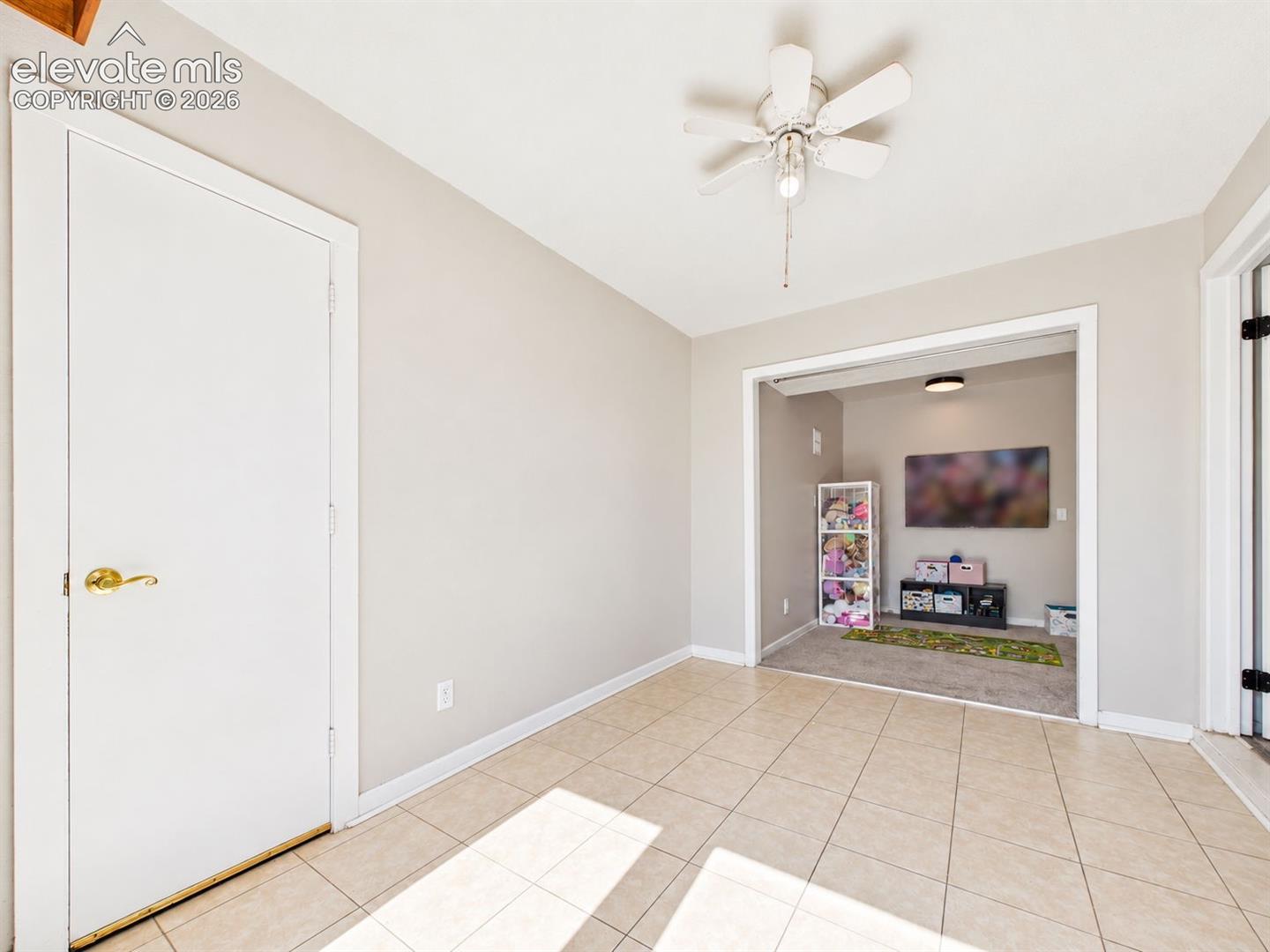 Alternate view shows the entry's open connection to an adjacent carpeted flex area, creating additional usable space near the front of the home.