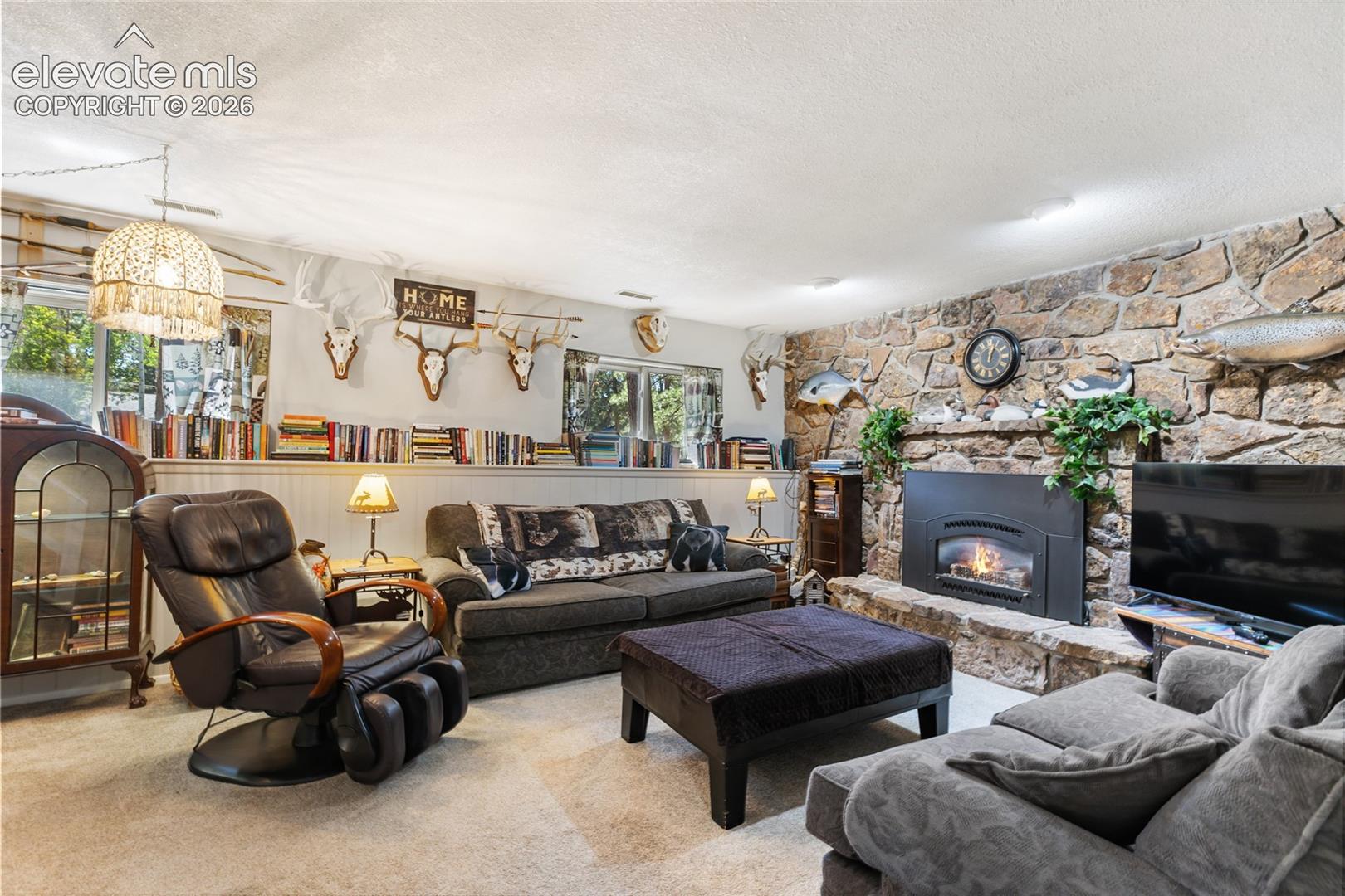Stone accent wall featuring a built-in fireplace