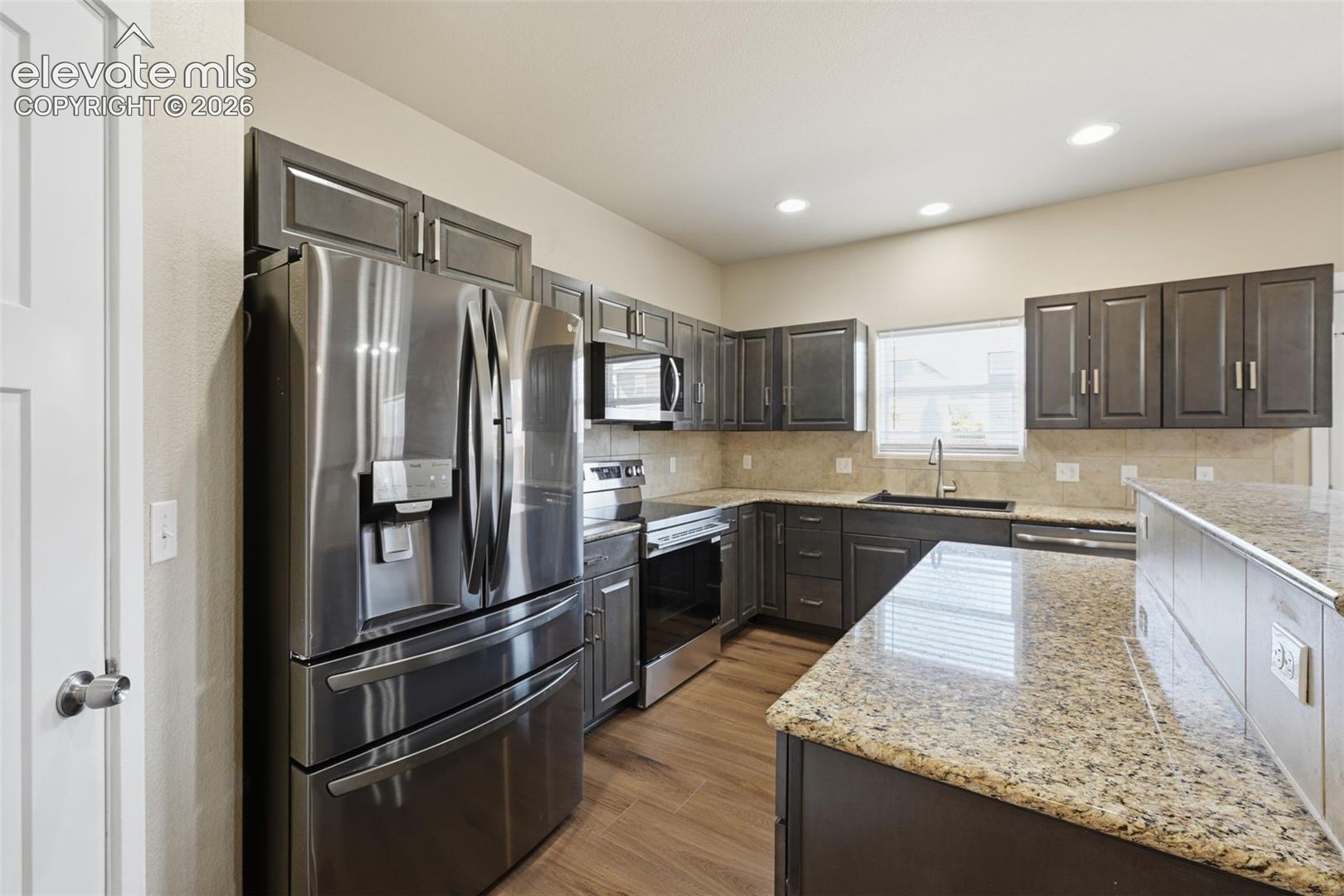 Generous counter space and stainless-steel appliances make the refreshed kitchen both functional and inviting.