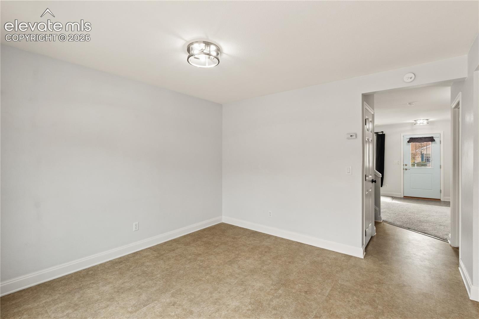 Neutral-toned interior featuring vinyl flooring and a flush-mount circular ceiling fixture