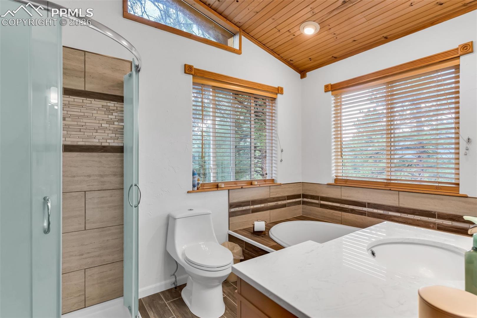 Primary bathroom with high ceilings and soaking tub