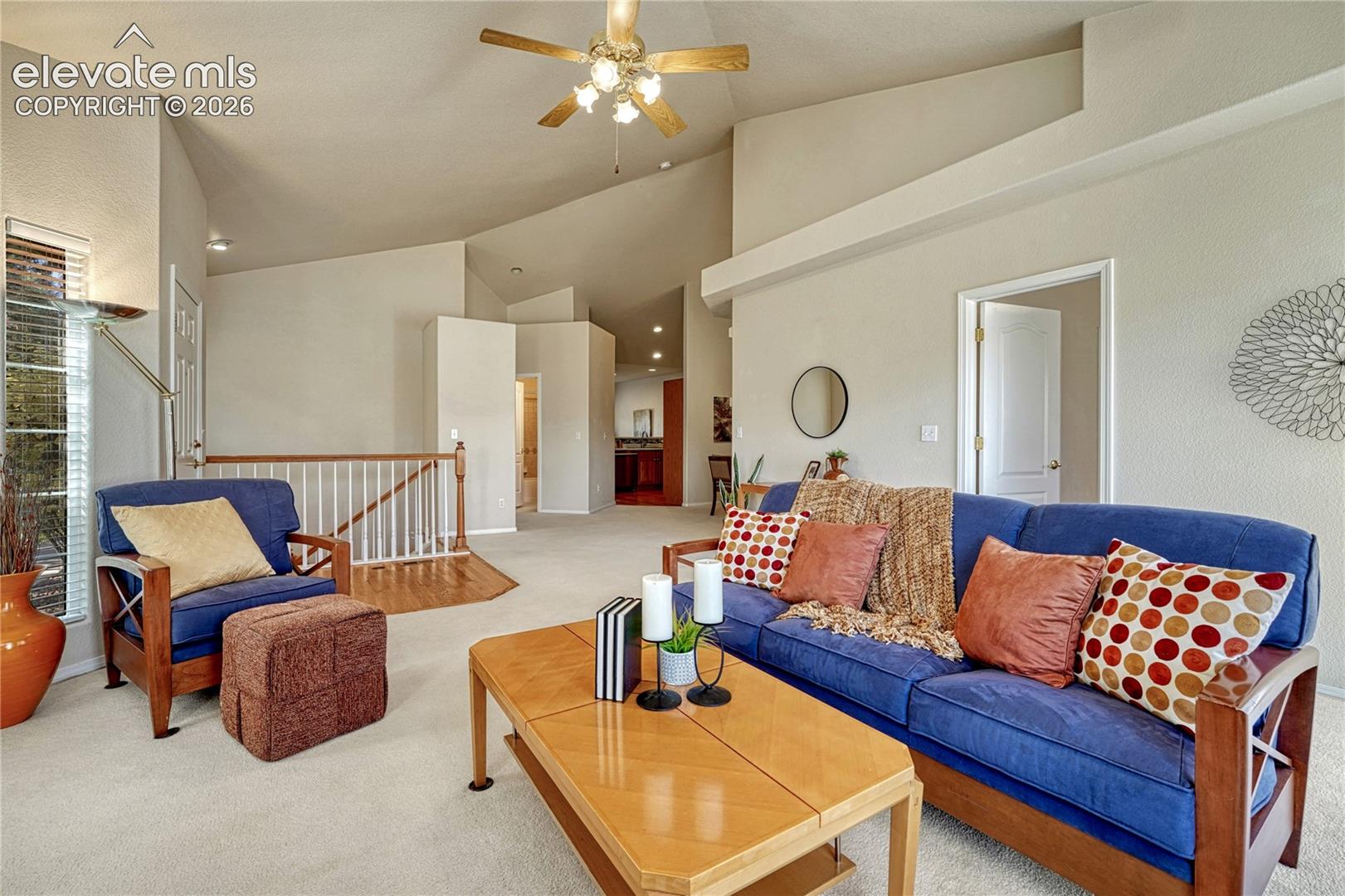 Soaring vaulted ceilings and an open-concept layout unite the entry, living, and dining areas in one cohesive, light-filled space
