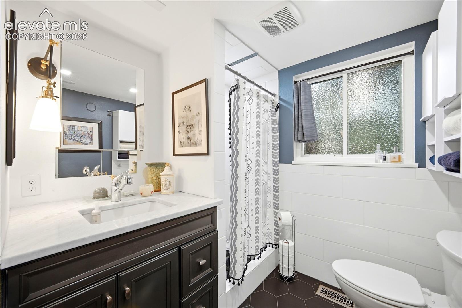 Main level bathroom between the kitchen and snug.