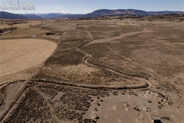 Overview of rural landscape with a desert landscape and a mountain backdrop