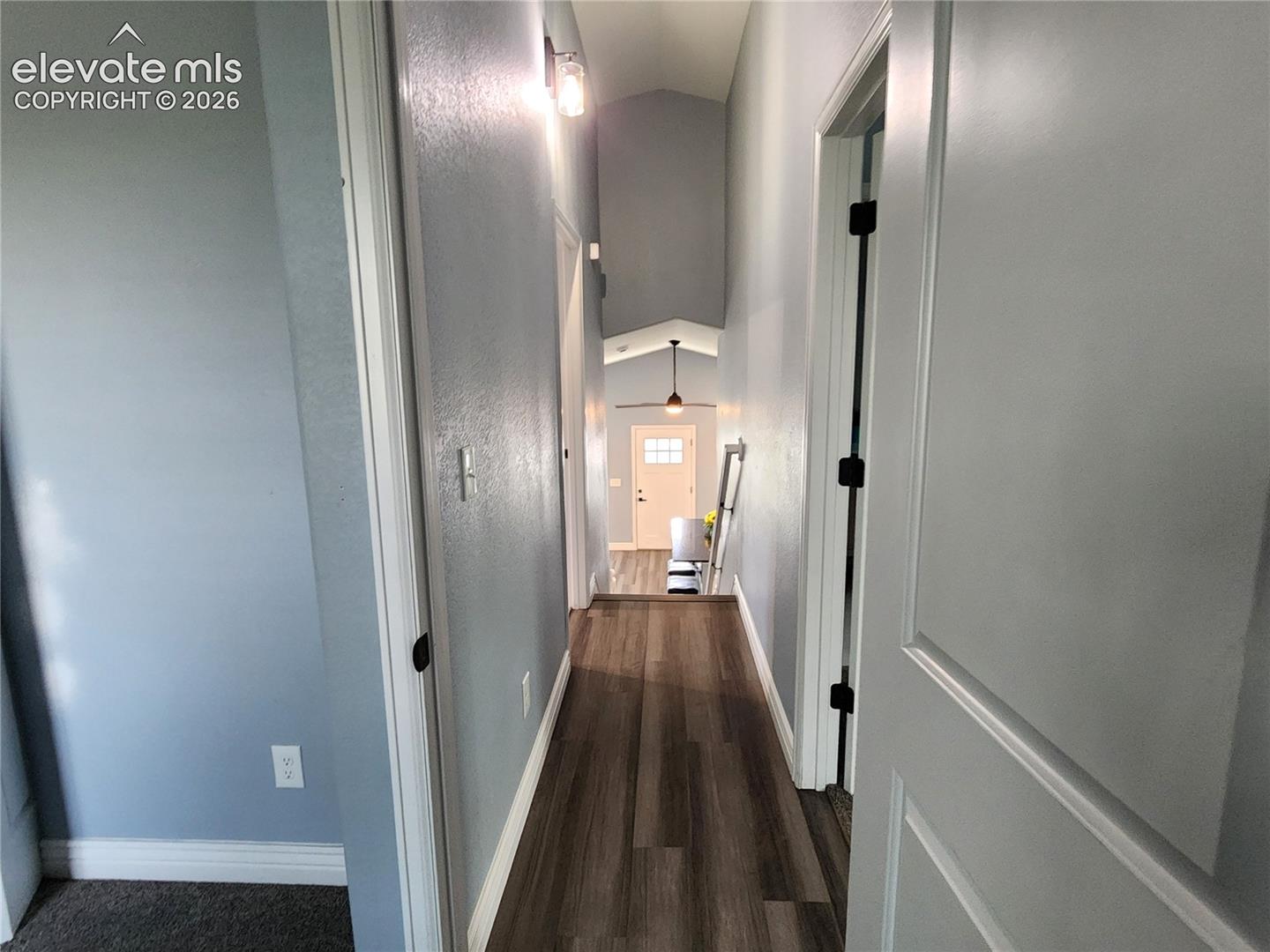 Bright upper-level hallway connecting the bedrooms and baths
