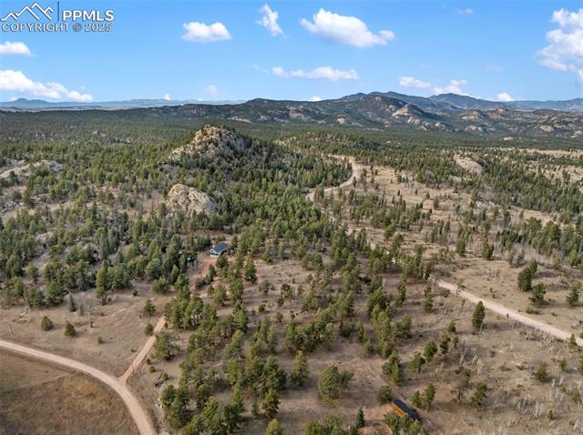 Aerial overview of property's location featuring a mountainous background