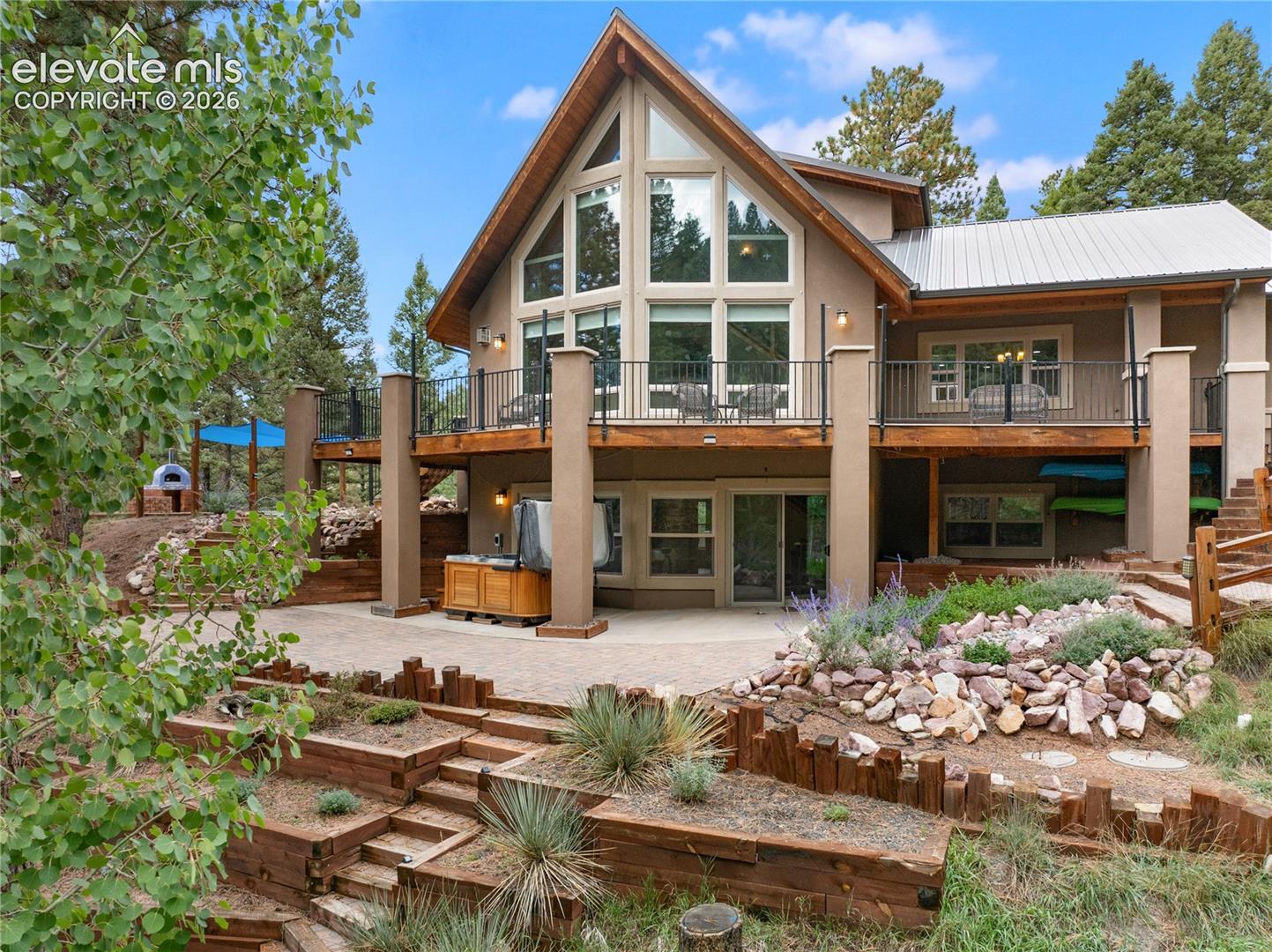 Immaculate Custom-built in 2013 and engineered for this mountain: 3060 Spruce Road is a structural insulated panel home on 6.3 private acres of ponderosa forest, minutes from town and bordered by trees on three sides. SIP construction (R-25 walls, R-38 roof) and radiant in-floor heat on all three levels make it remarkably quiet, tight, and inexpensive to heat, and a new Rinnai condensing combi boiler installed in 2026 supplies both the heat and endless on-demand hot water. A hard-wired Generac whole-house generator conveys. Inside, a vaulted tongue-and-groove great room opens through a custom prow of glass to surveyed mountain views, with a stone-surround gas fireplace beside it. Porcelain tile floors and quartz countertops run throughout, over custom cabinetry, and the kitchen has a new LG smart induction range. Five bedrooms across three levels include a private loft primary suite with a walk-in closet. The walk-out lower level adds a family room, two bedrooms, and a dedicated pub room opening to the patio. Three-car garage, central vacuum, new blinds, fresh paint. Large mechanical and storage room in Lower Level. Metal roof, stucco exterior, paved driveway-low exterior maintenance. Wrap around deck, expansive patio, hot tub and a pizza oven. Enjoy the peace and quiet and your own hiking trails in your backyard. Move in ready !!! Pleasure to show!