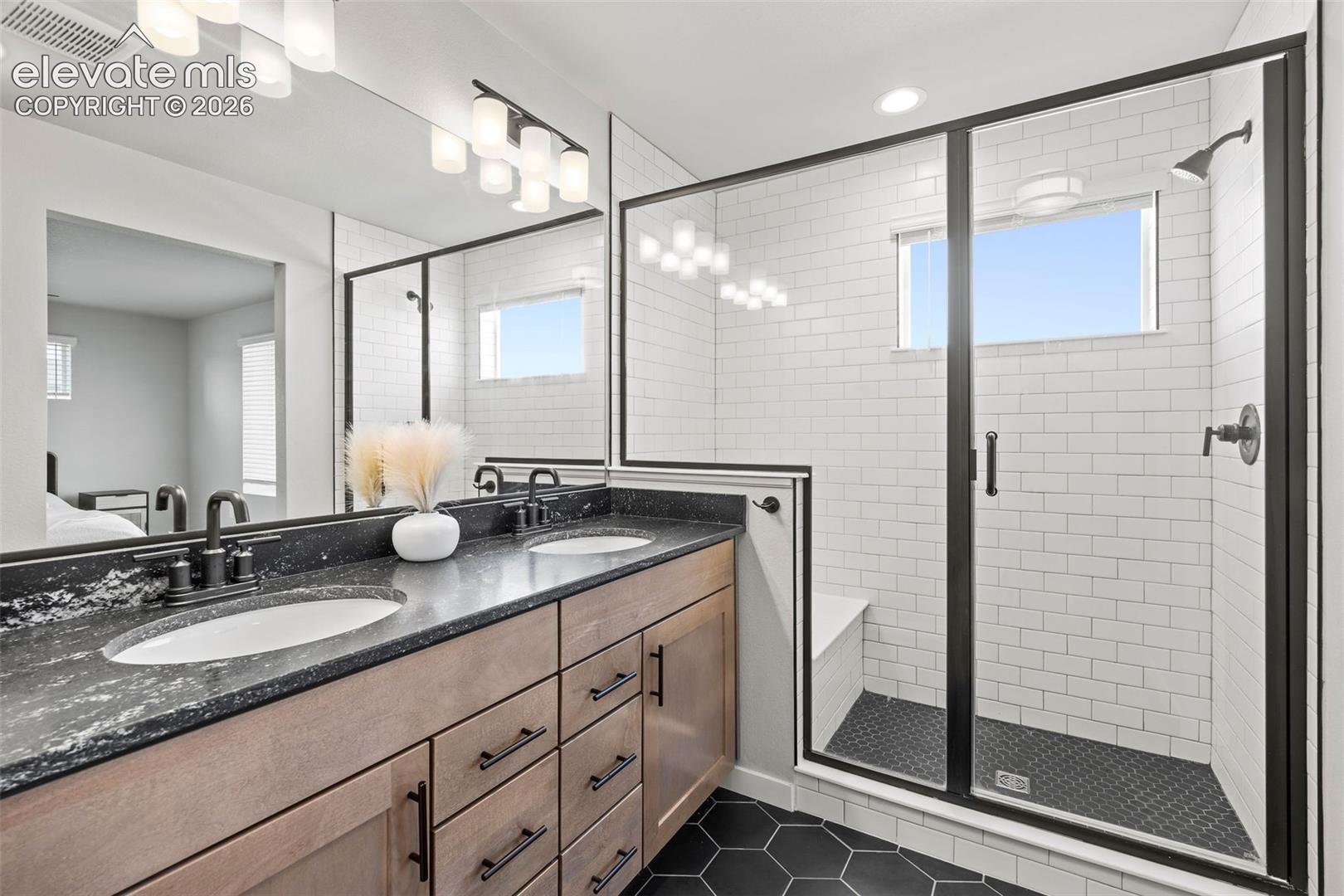 Gorgeous tilework and a built-in seat make the double-sized shower an absolute show-stopper.