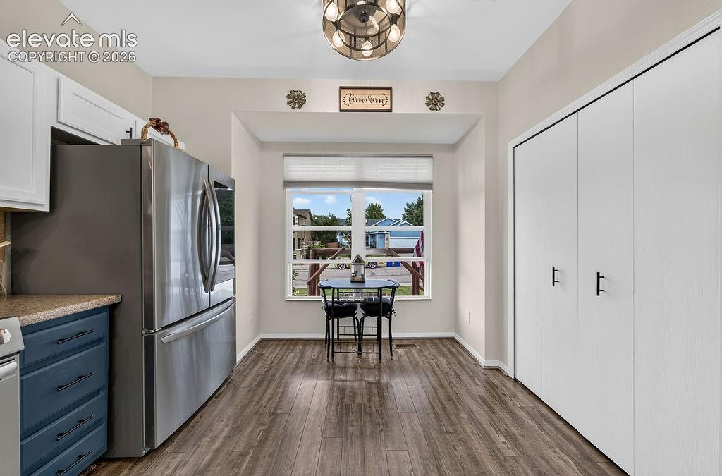 Recessed window nook with a built-in window sill, wood-finish flooring, and a modern ceiling fixture