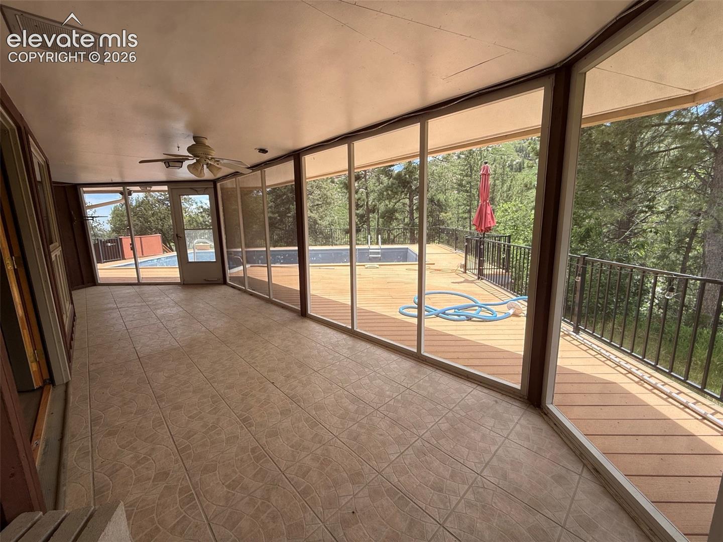 Sunroom off living room leads to pool deck