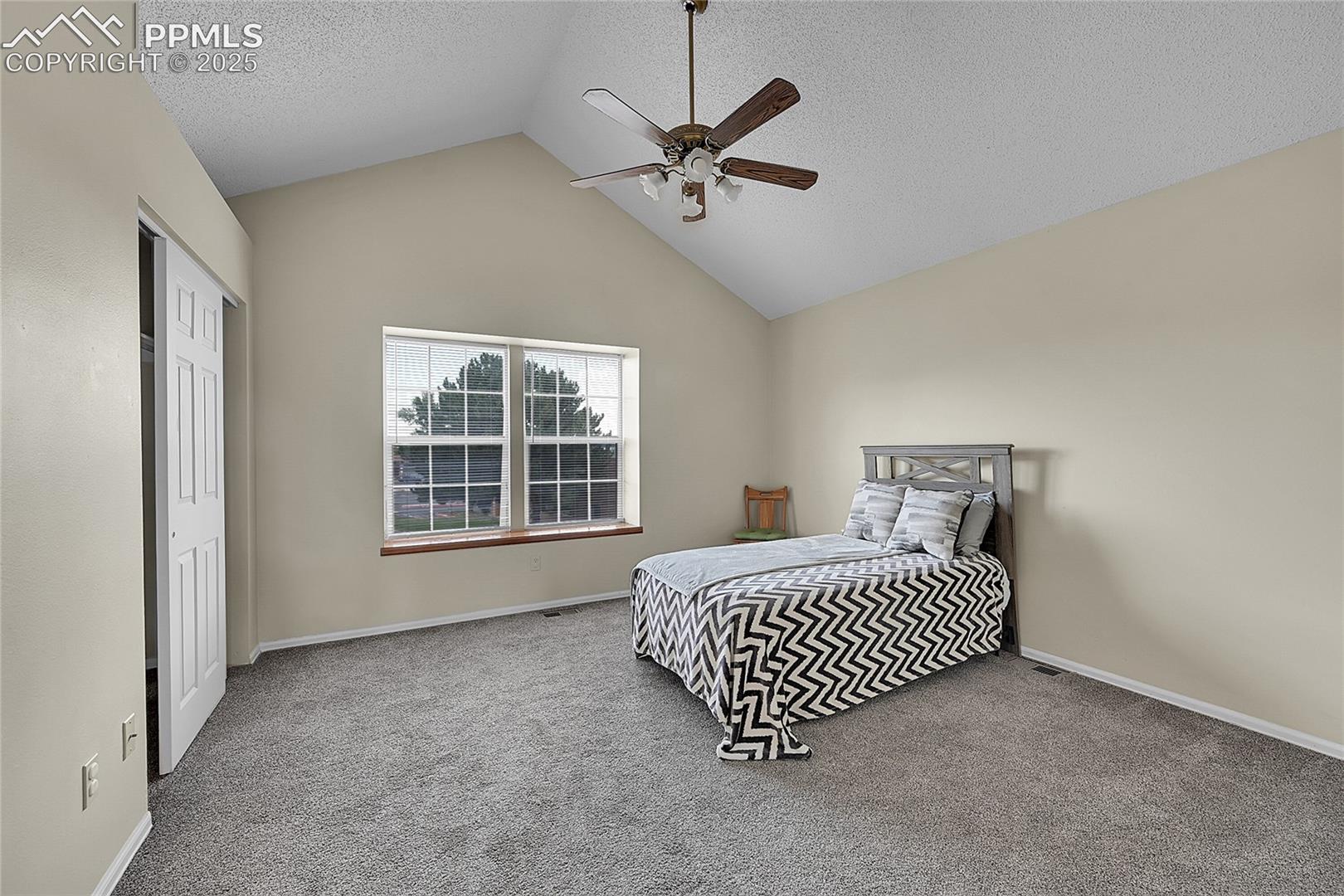 Primary bedroom featuring vaulted ceiling and adj. bathroom