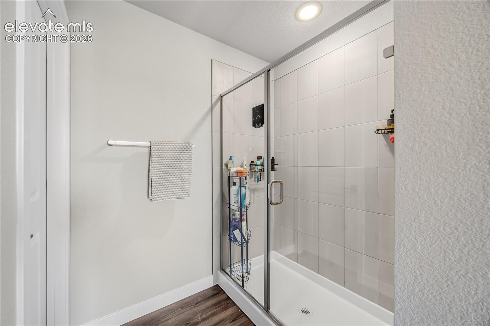 Enclosed tiled shower in the Primary Bathroom.