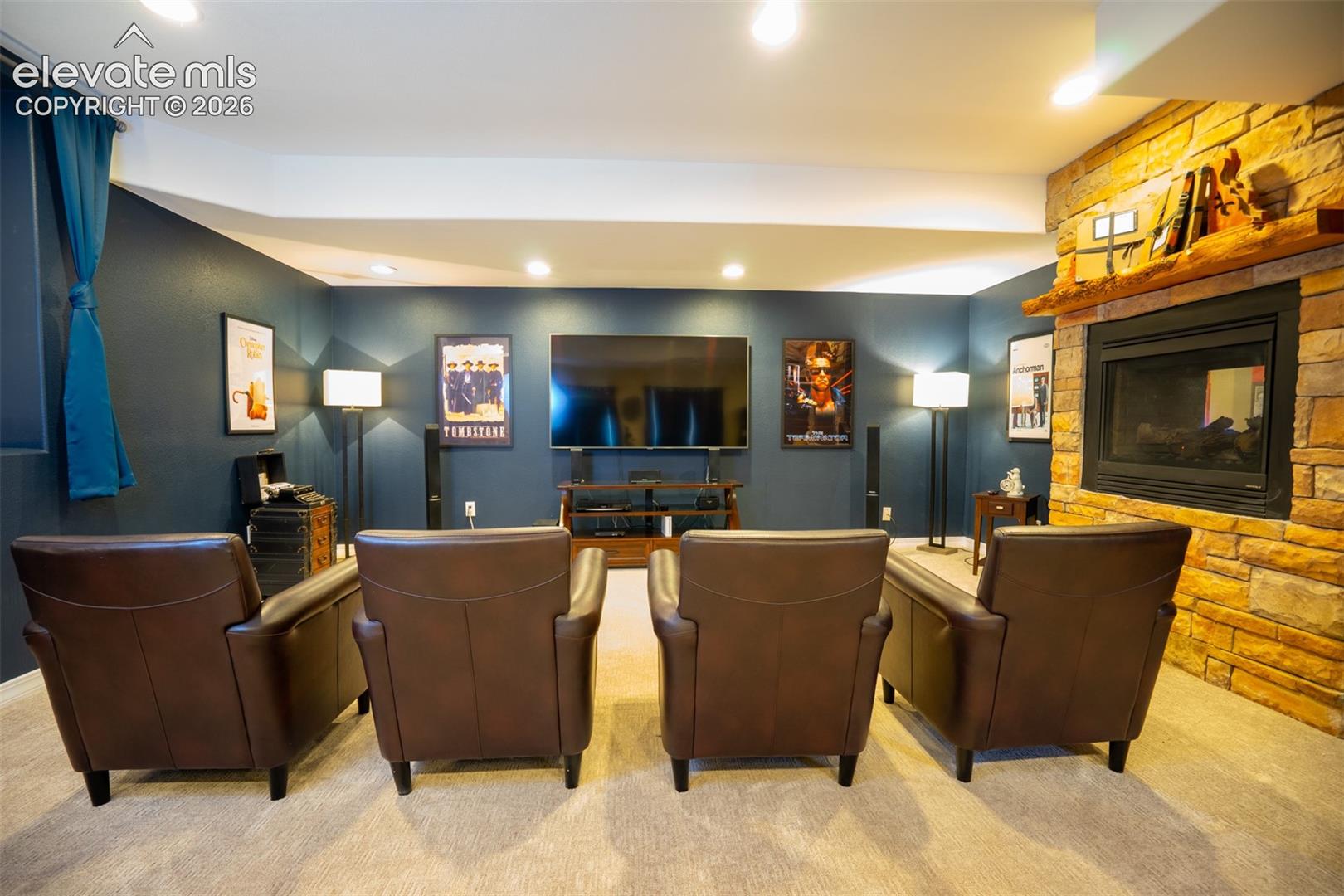 Head down to the basement level for the home within a home. Enjoy a theater setting or use this as a secondary family room. Notice the 2-way fireplace that's between the family room and kitchen/dining area on the other side