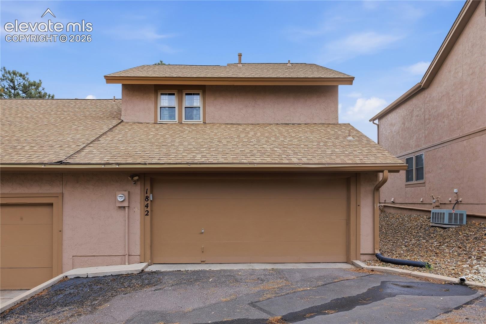 Stucco exterior with an attached garage