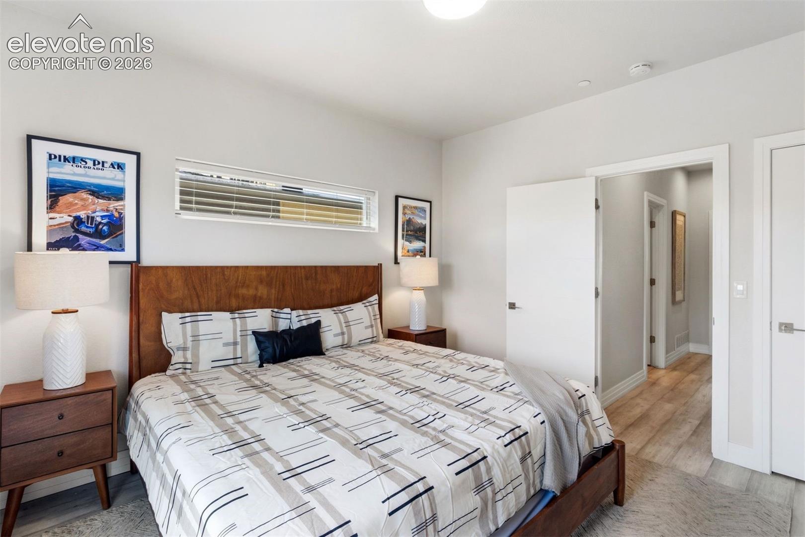 Primary bedroom with ensuite bathroom, walk-in closet, and private deck with roof top access